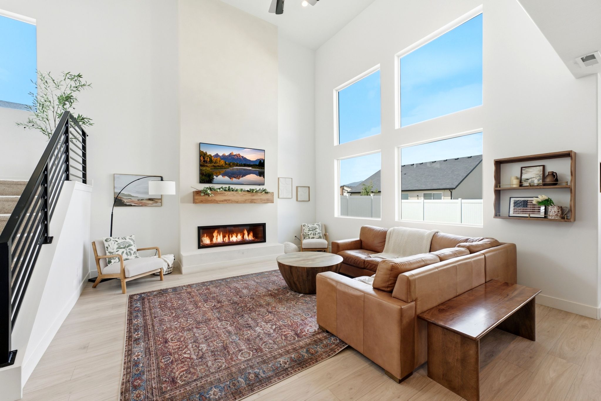 Vaulted living area featuring wood-finish flooring and a contemporary linear fireplace