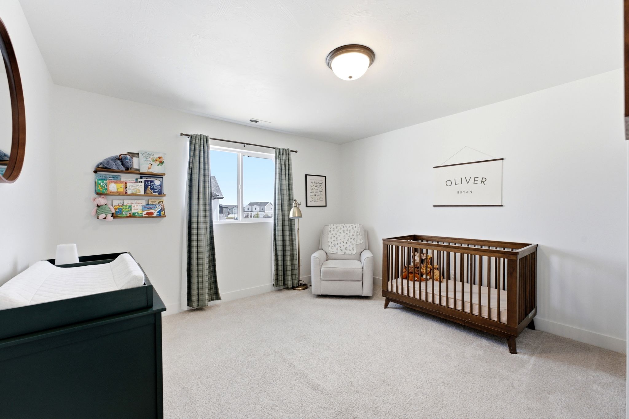 Light-filled interior space featuring a window, light-toned carpeting, white walls, and a flush mount ceiling light fixture