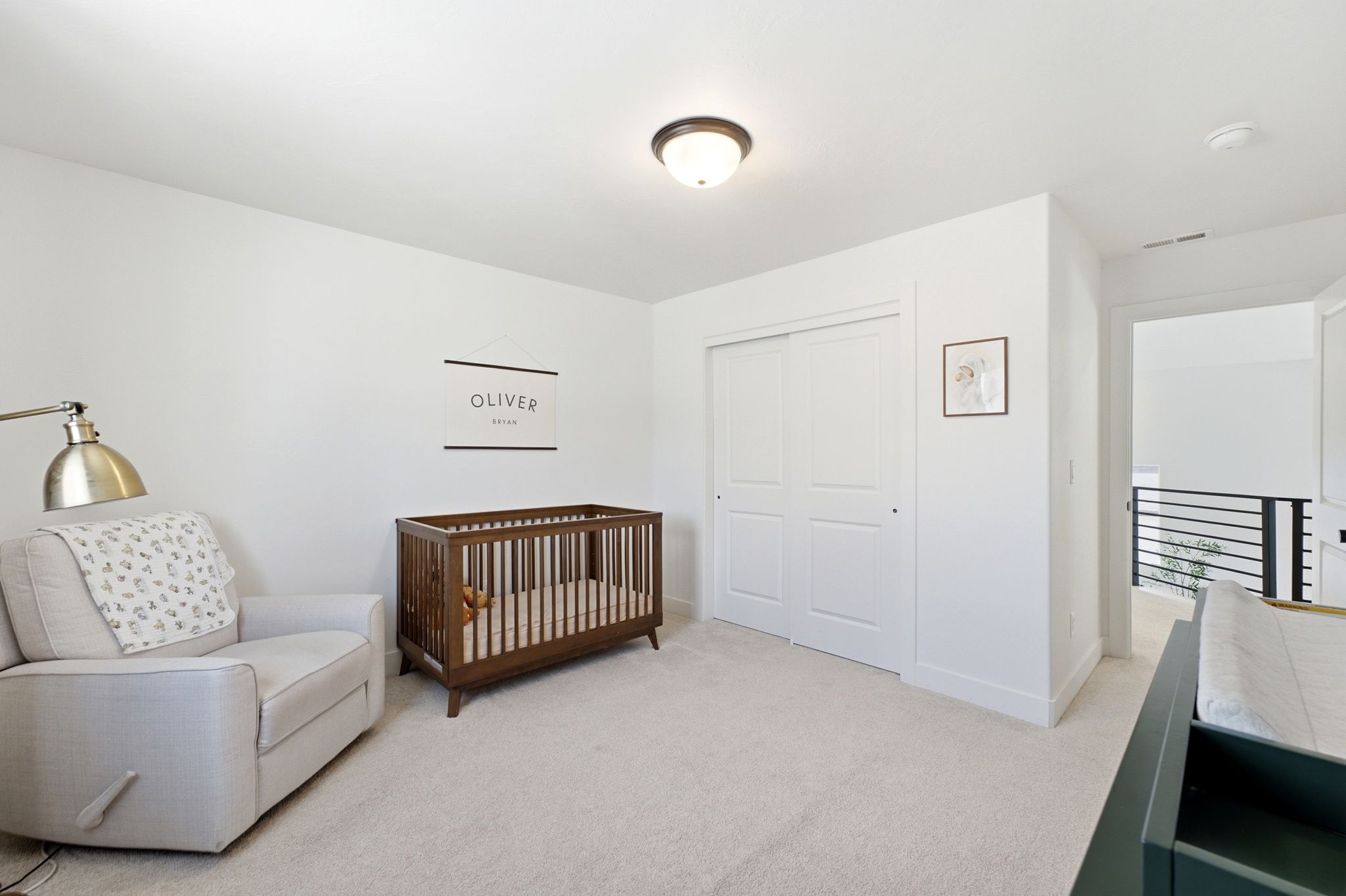 Spacious room featuring light-colored carpeting and white walls
