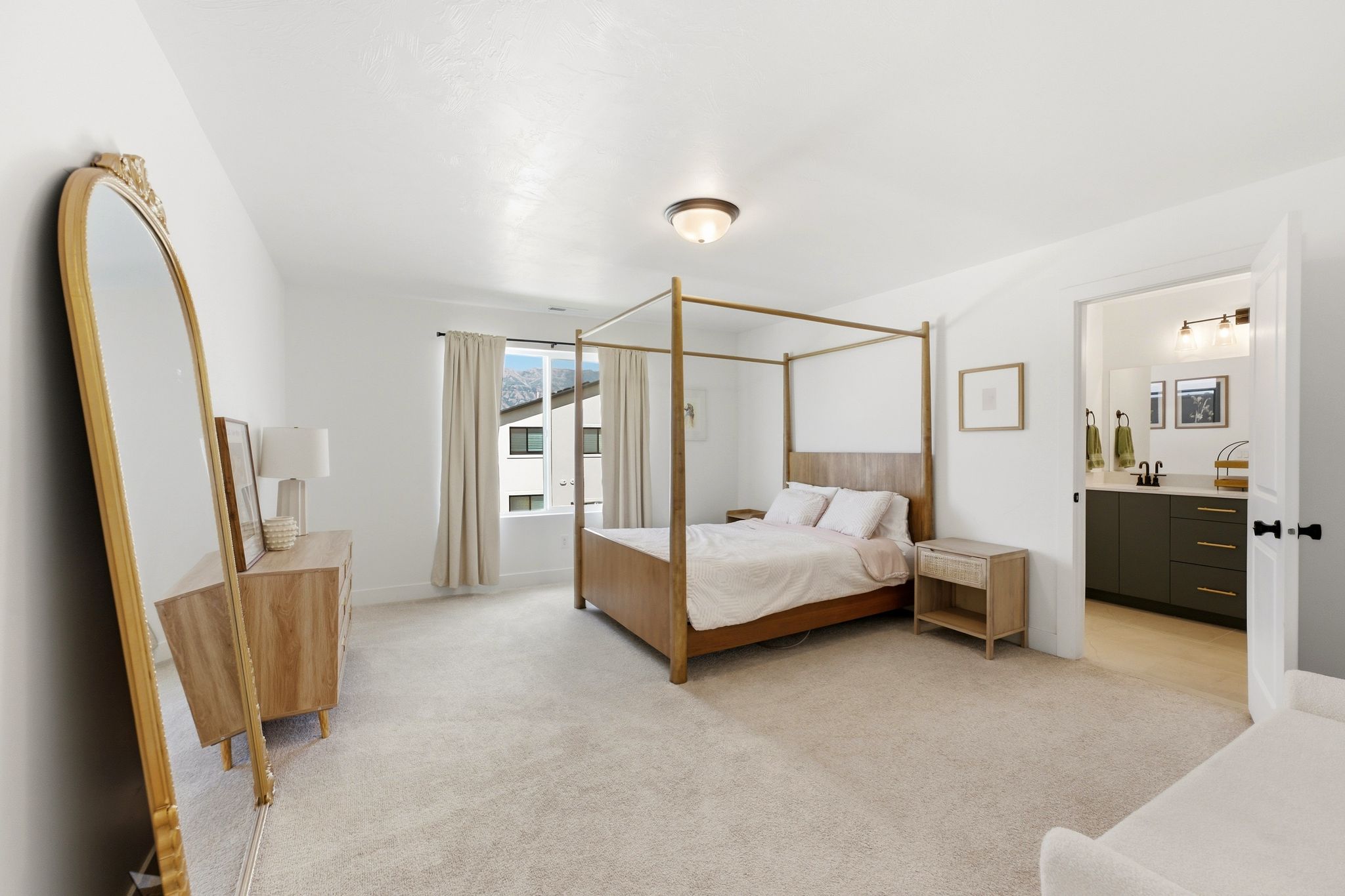 Bright bedroom featuring plush carpet flooring, a window with exterior views, and a ceiling-mounted light fixture