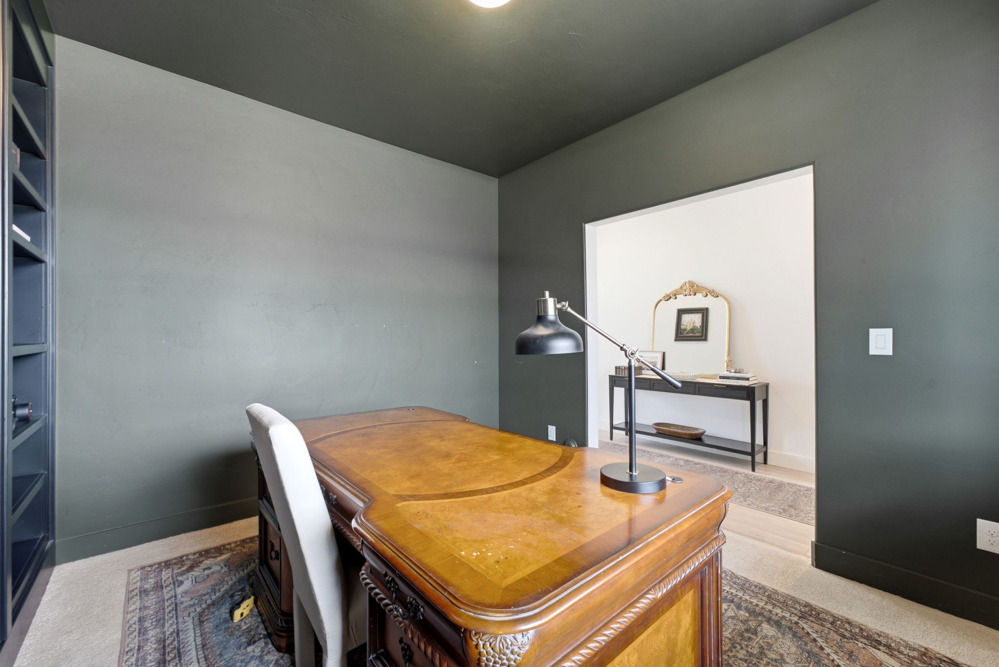 Office space featuring dark-painted walls and a coordinating ceiling