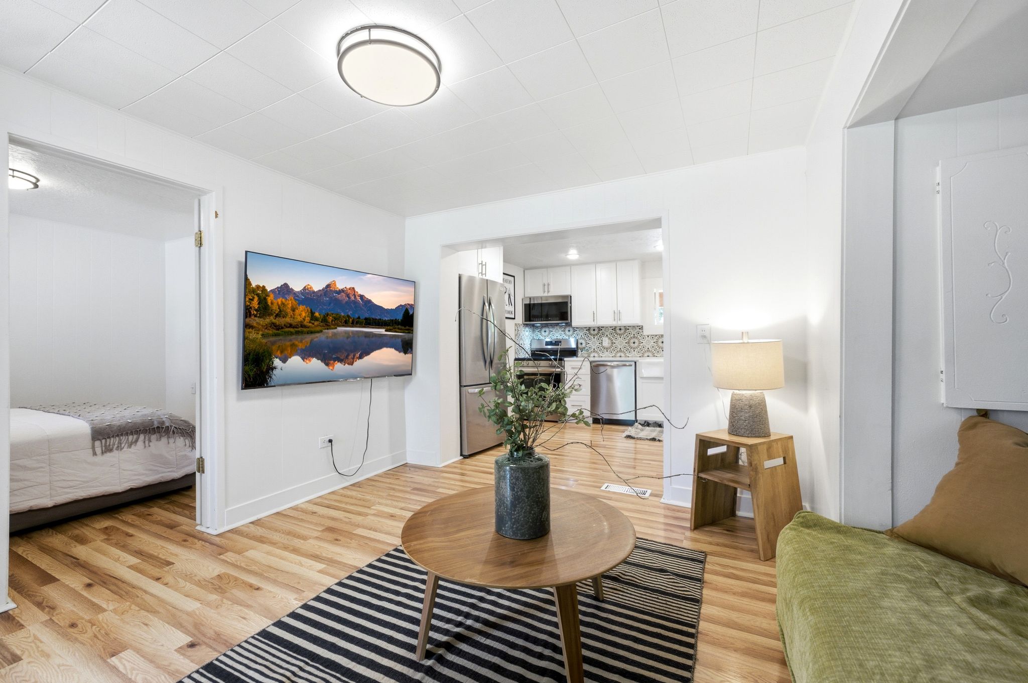 Open-concept living area featuring wood-finish flooring, recessed lighting, and a white ceiling