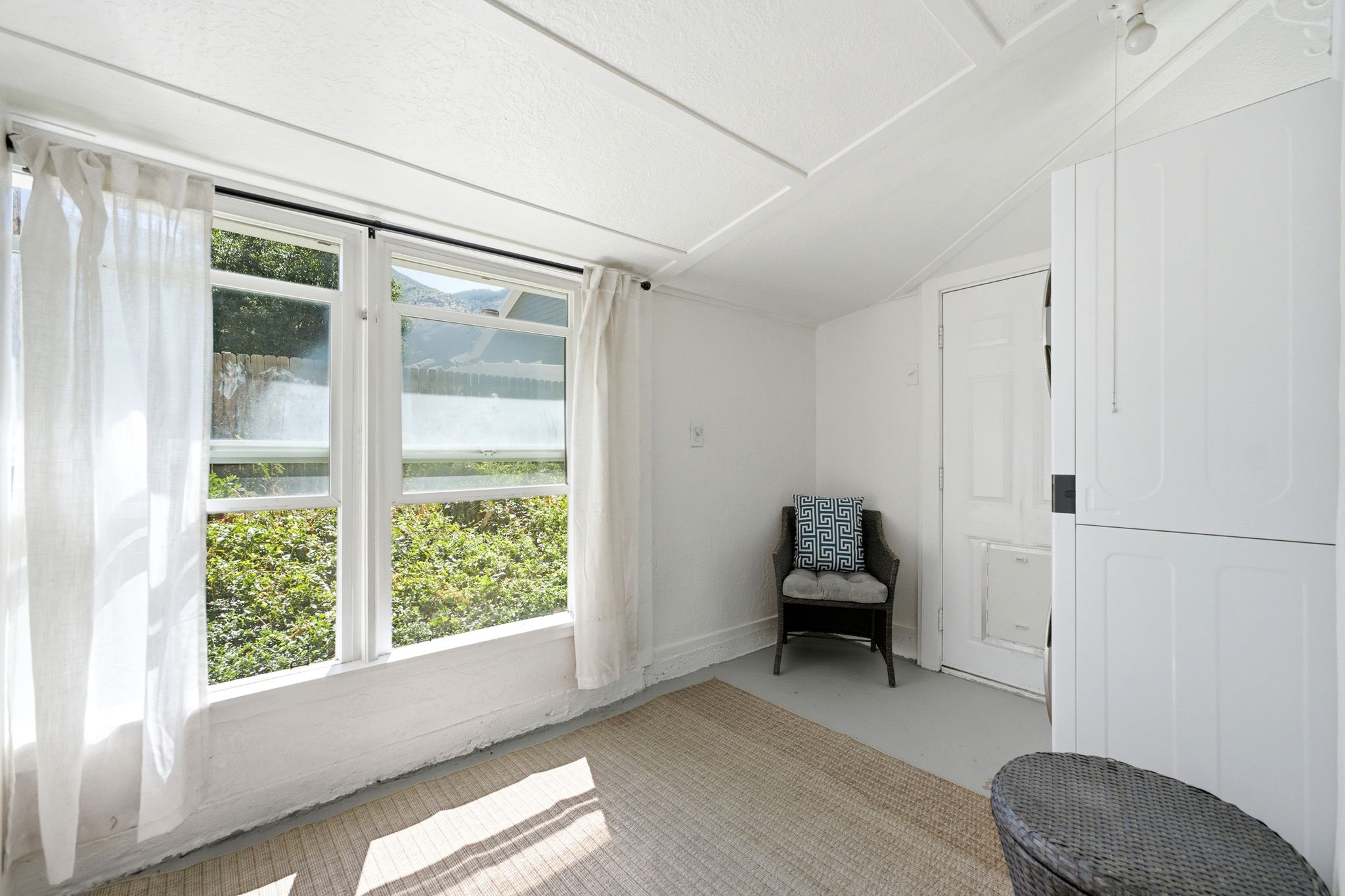 Extra Large Laundry room, Bright room with multiple windows, painted white trim, and a high ceiling