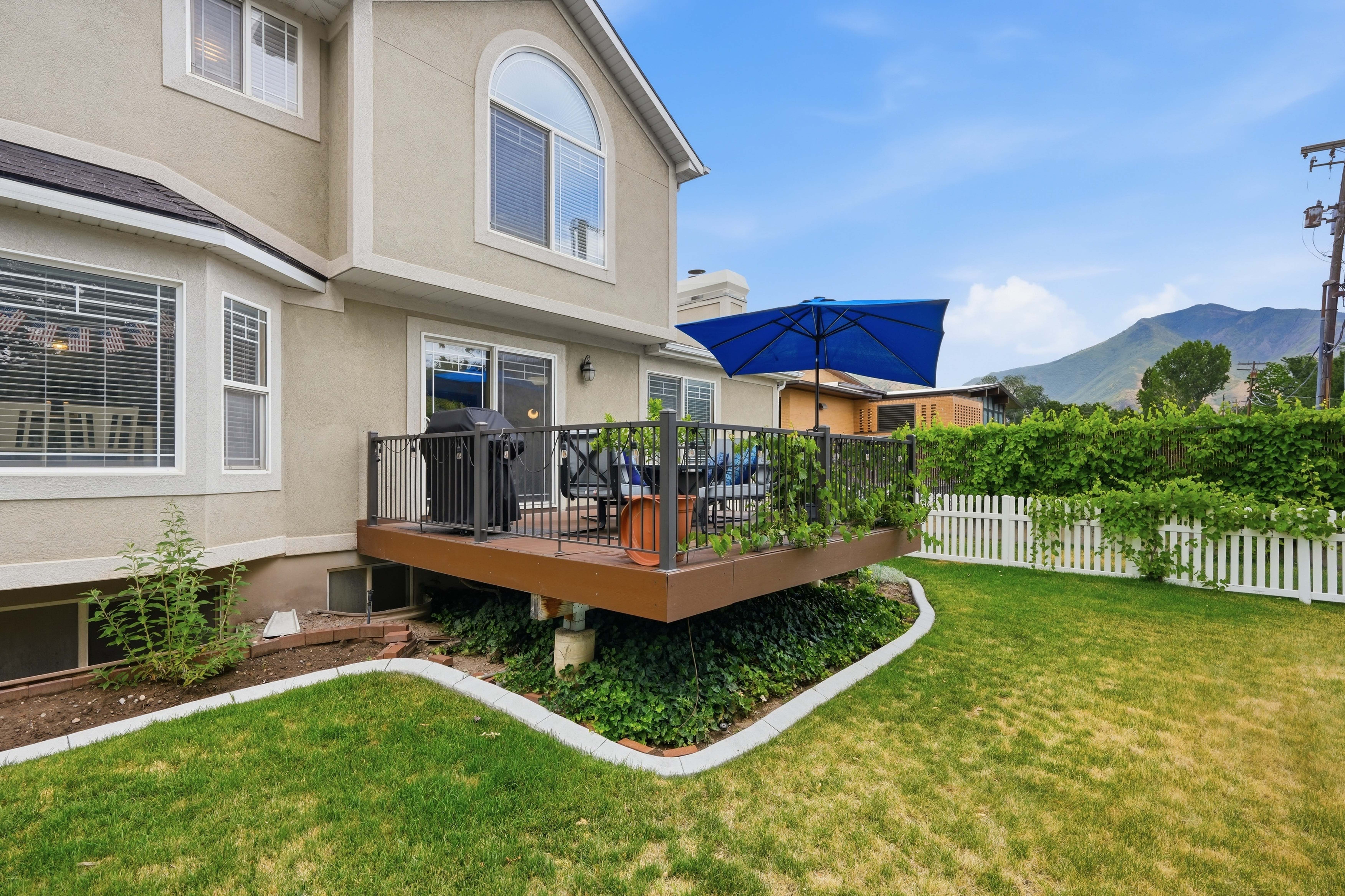 Elevated deck featuring dark railings and a sliding glass door entry