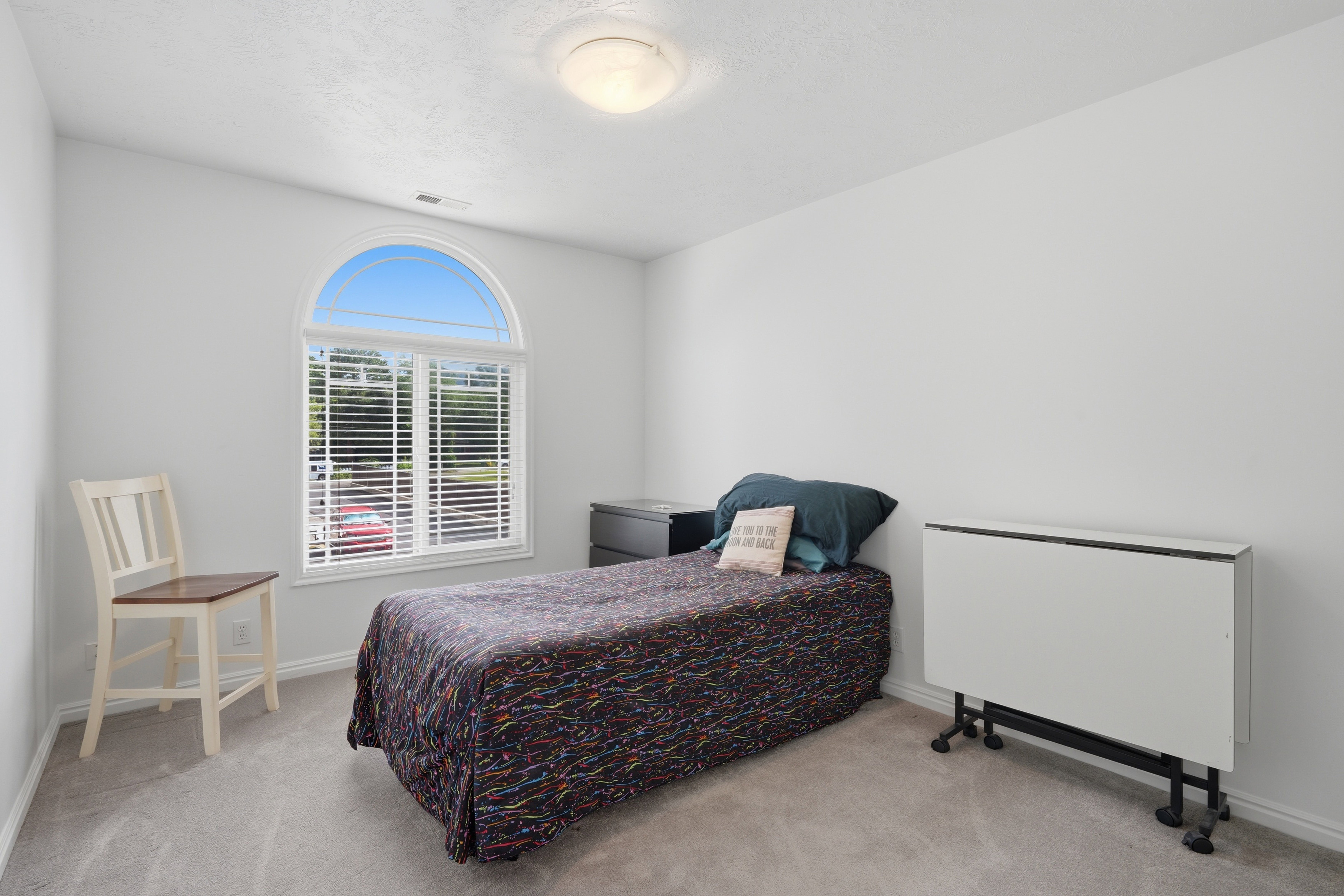 Bright room with light gray carpeting and white walls