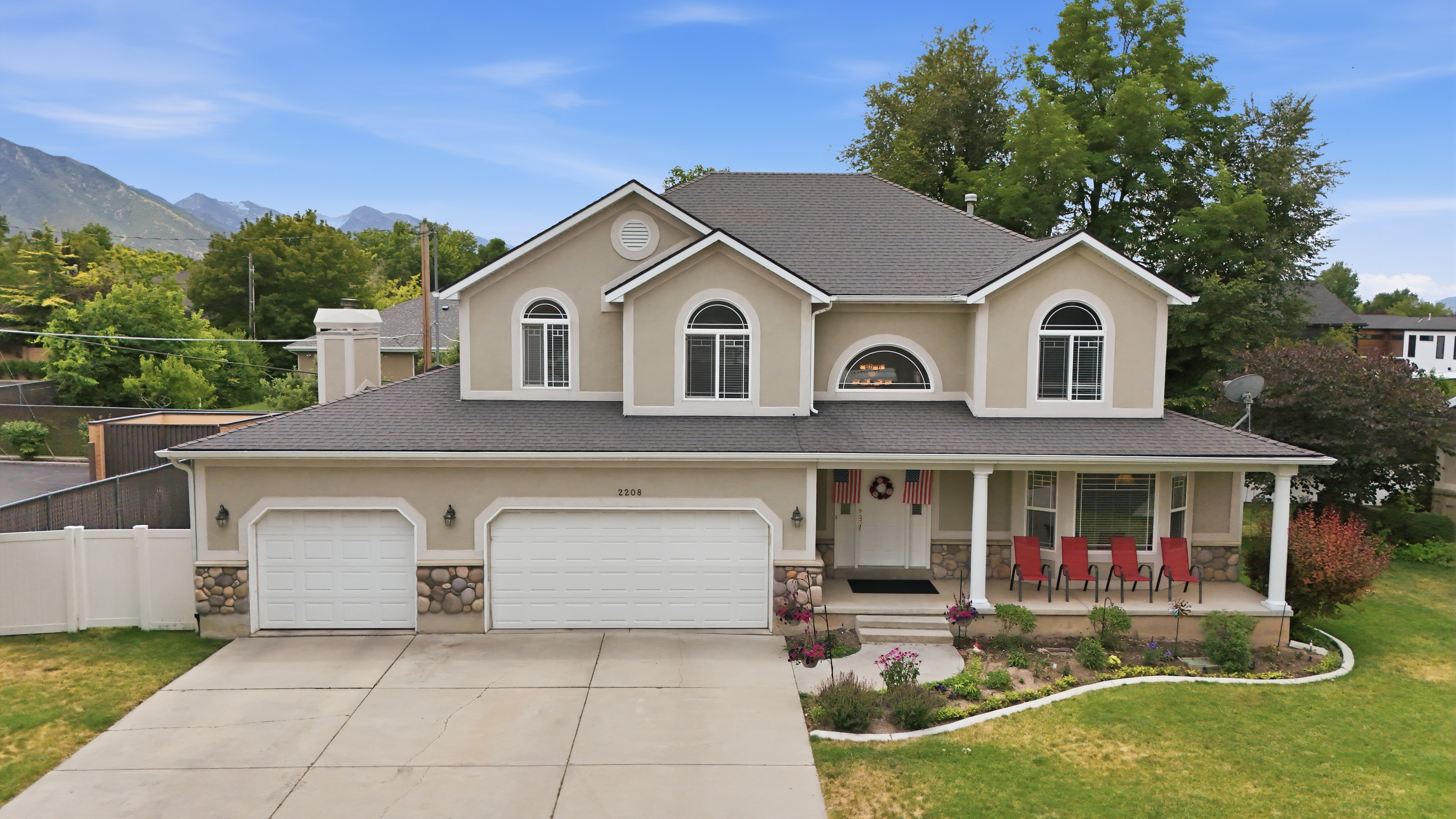 Stucco exterior with stone accents and a covered front porch