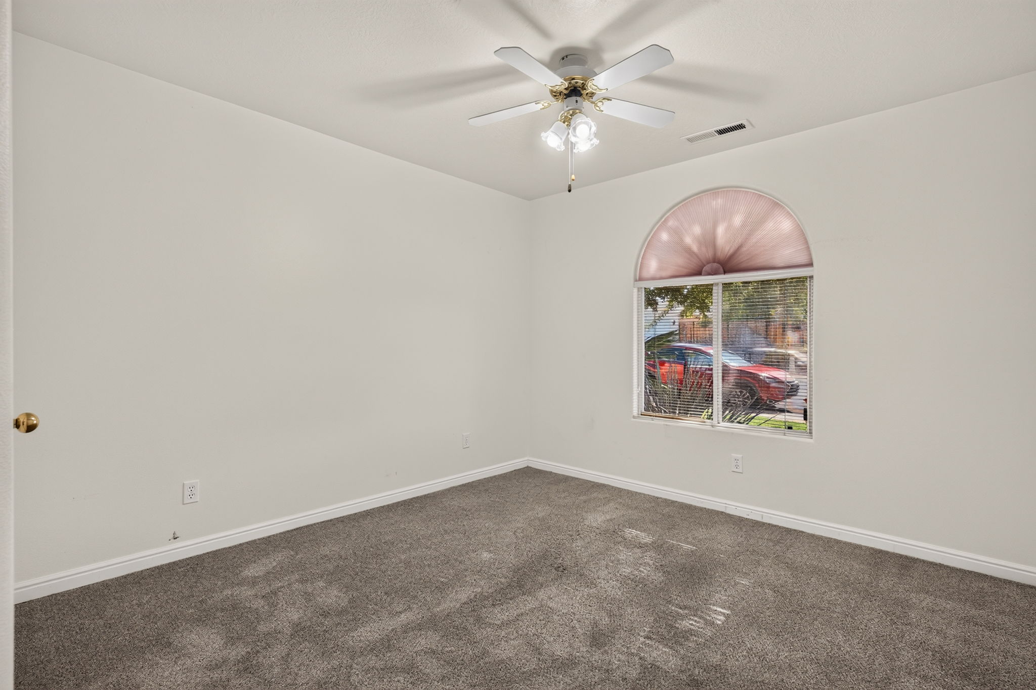 Room featuring grey carpeting, white walls, and a ceiling fan with integrated lighting
