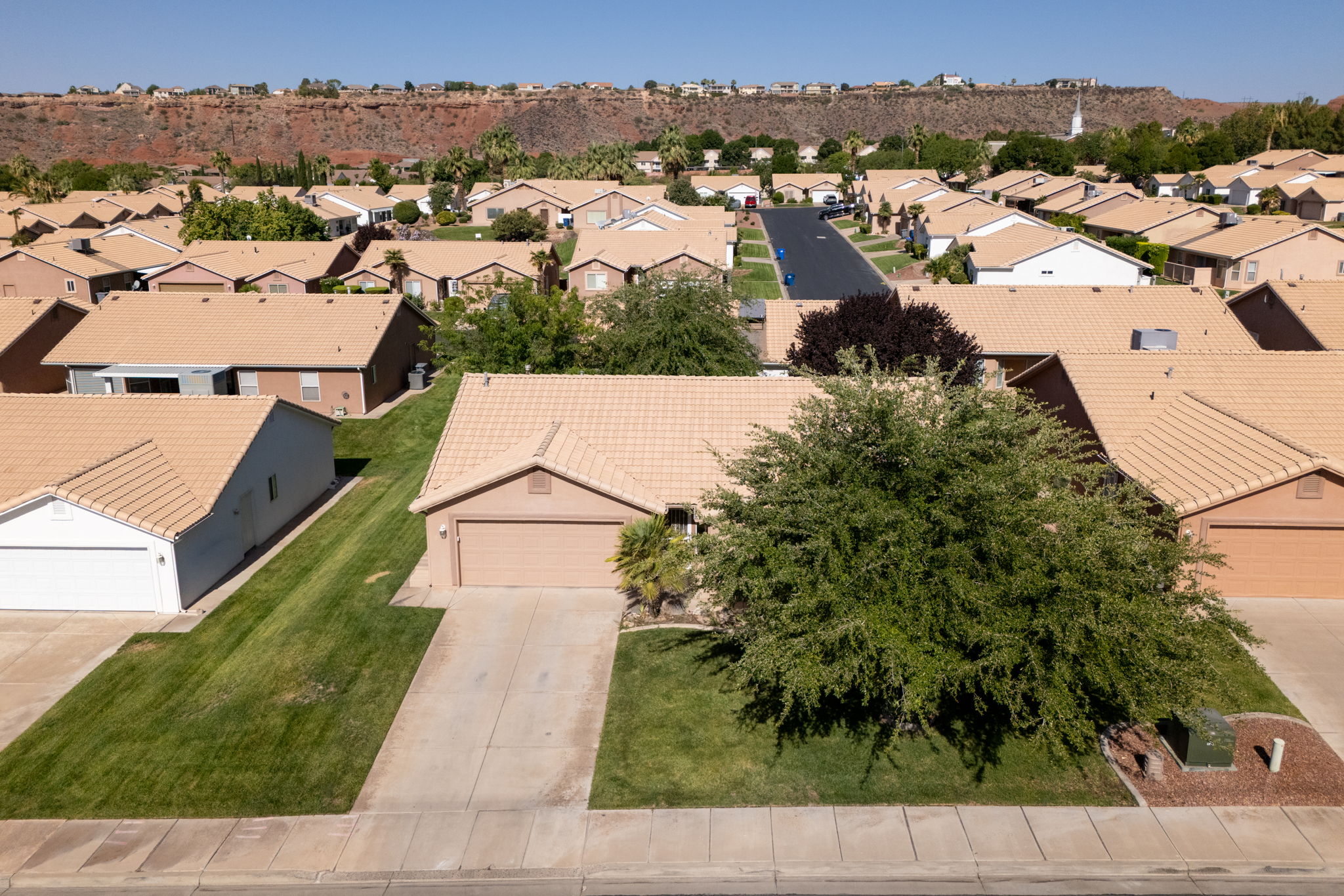 Single-story residence featuring a tan stucco exterior and a matching tile roof