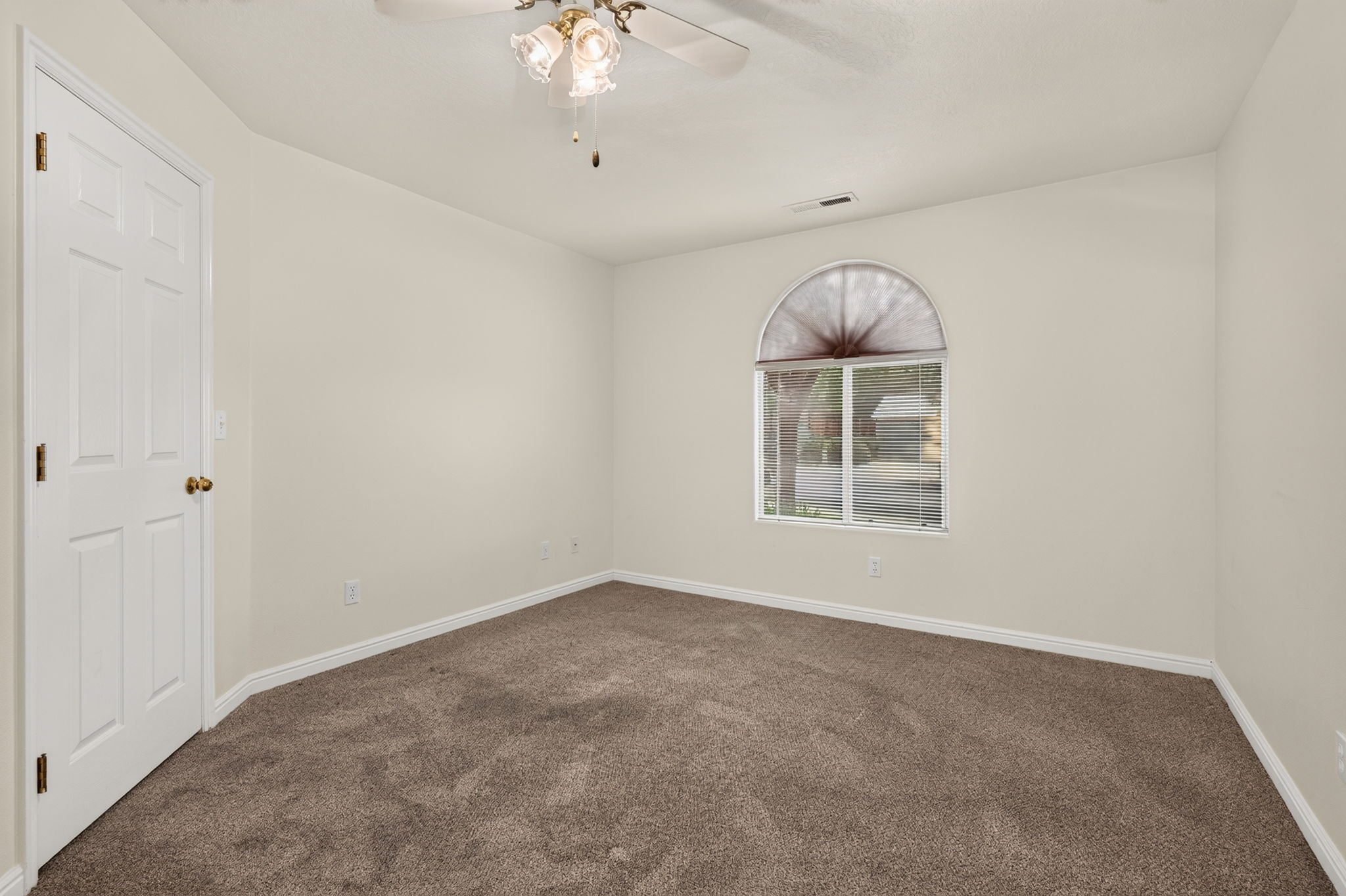 Neutral wall tones complement plush carpet flooring