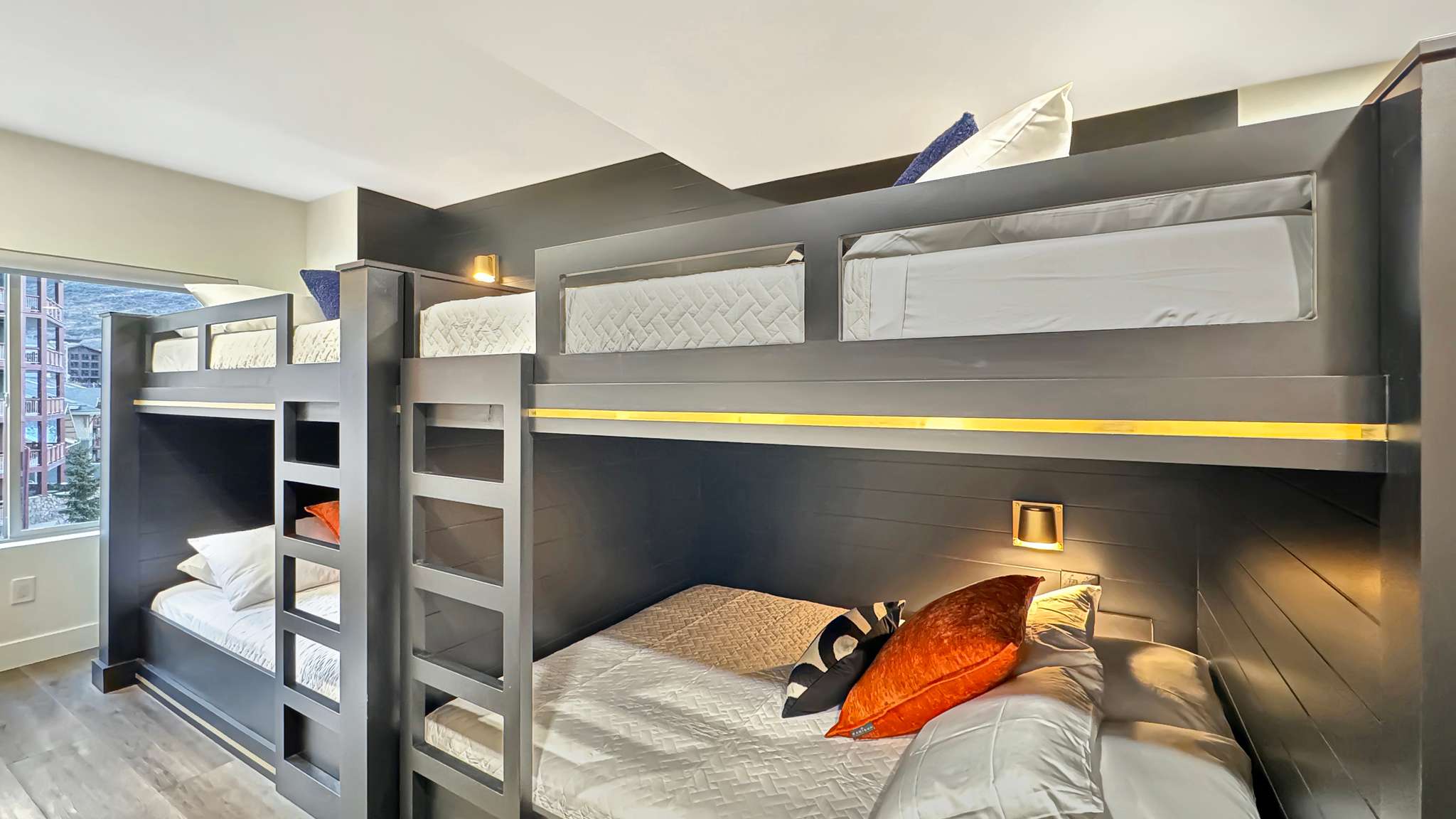 Built-in bunk beds with integrated ladders and individual lighting fixtures