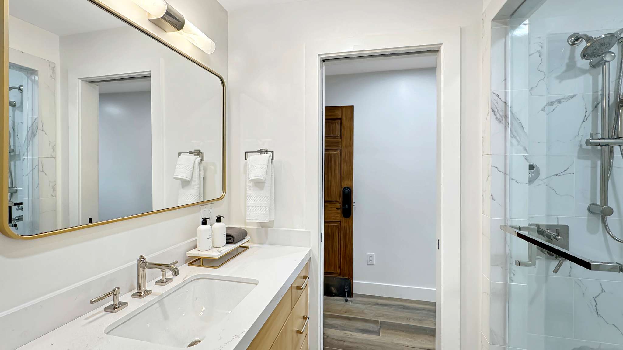 Contemporary bathroom featuring a spacious vanity with an undermount sink and a light-toned countertop