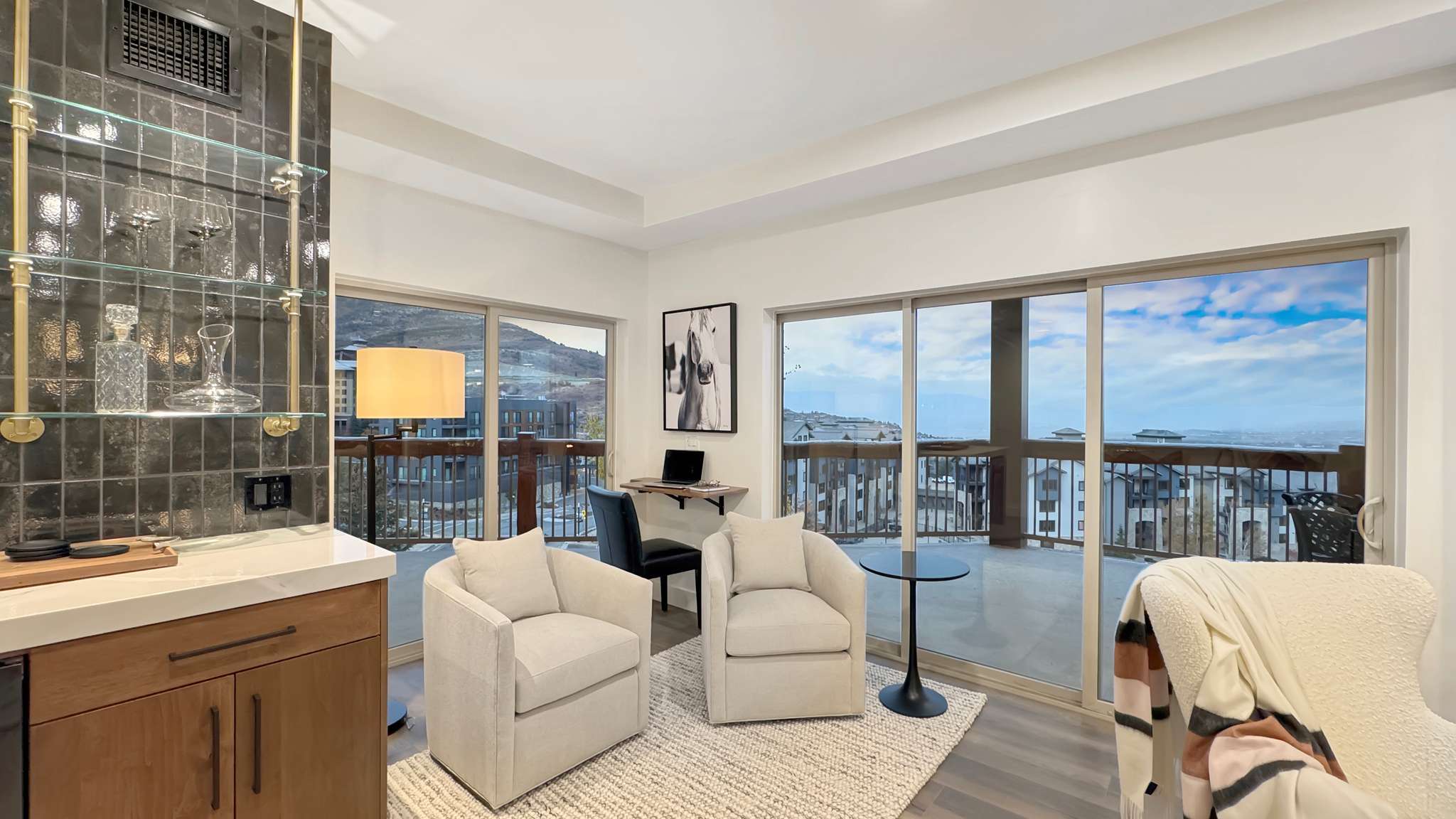 Spacious room with large sliding glass doors opening to an expansive outdoor deck
