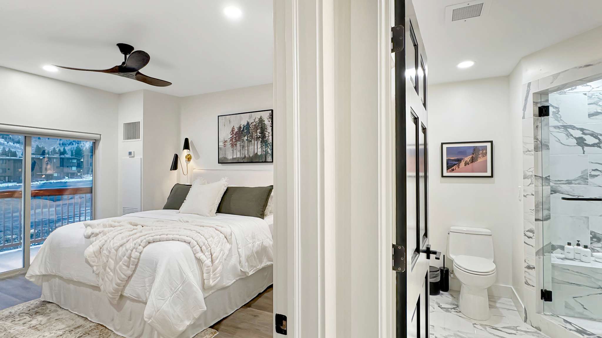 Bedroom featuring a sliding glass door to a balcony, wood-finish flooring, and a ceiling fan