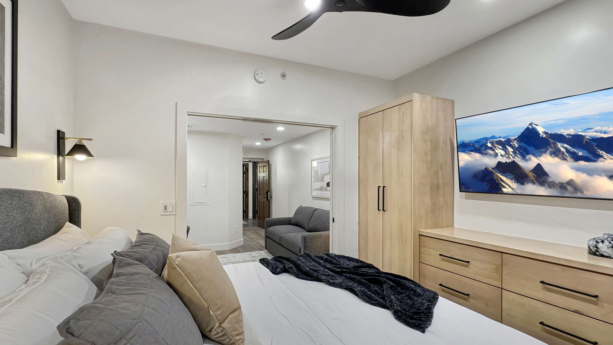 Recessed lighting with a ceiling fan, light wood-finish built-in wardrobe, and matching dresser cabinetry