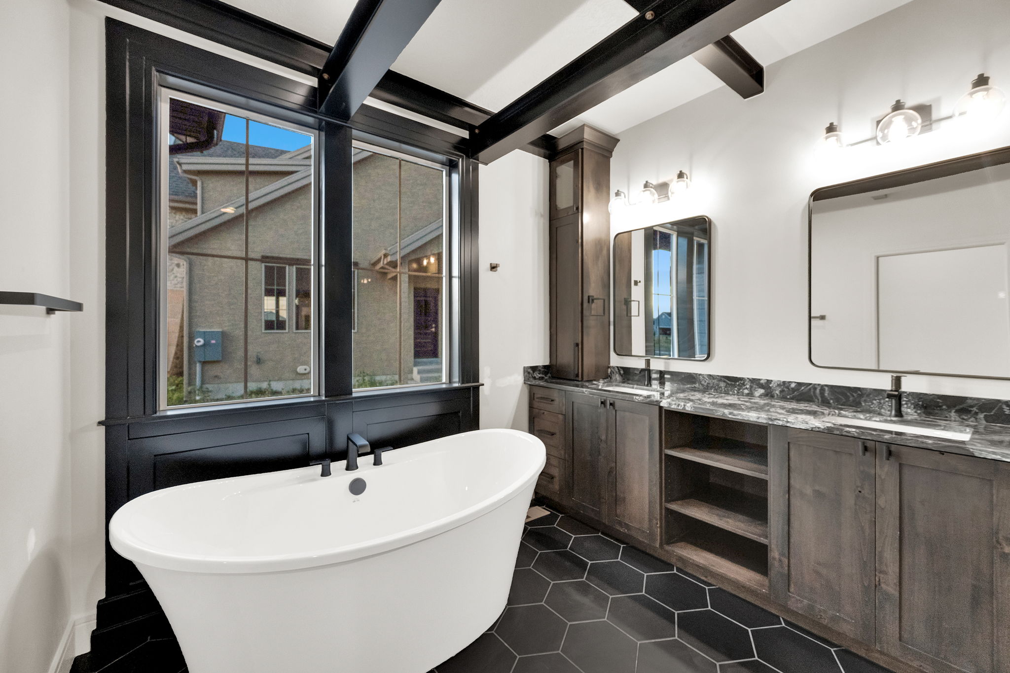 Freestanding soaking tub with a matte black faucet