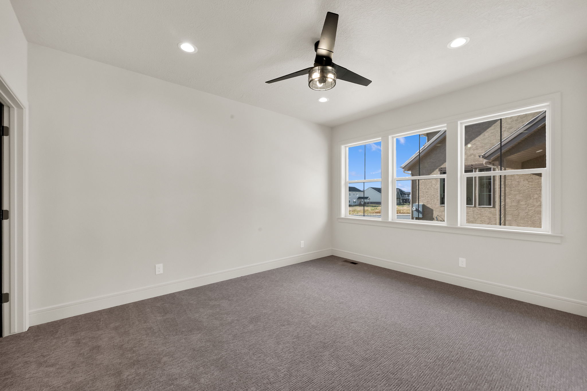 Neutral-toned carpeting paired with white baseboards