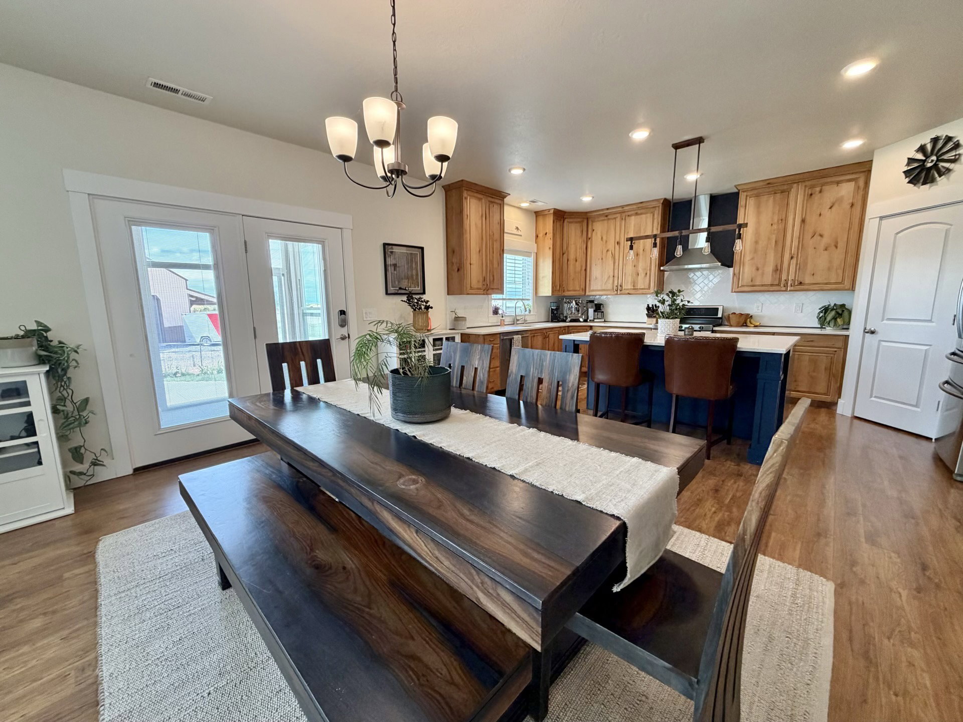 Open-concept dining and kitchen area featuring wood-finish flooring