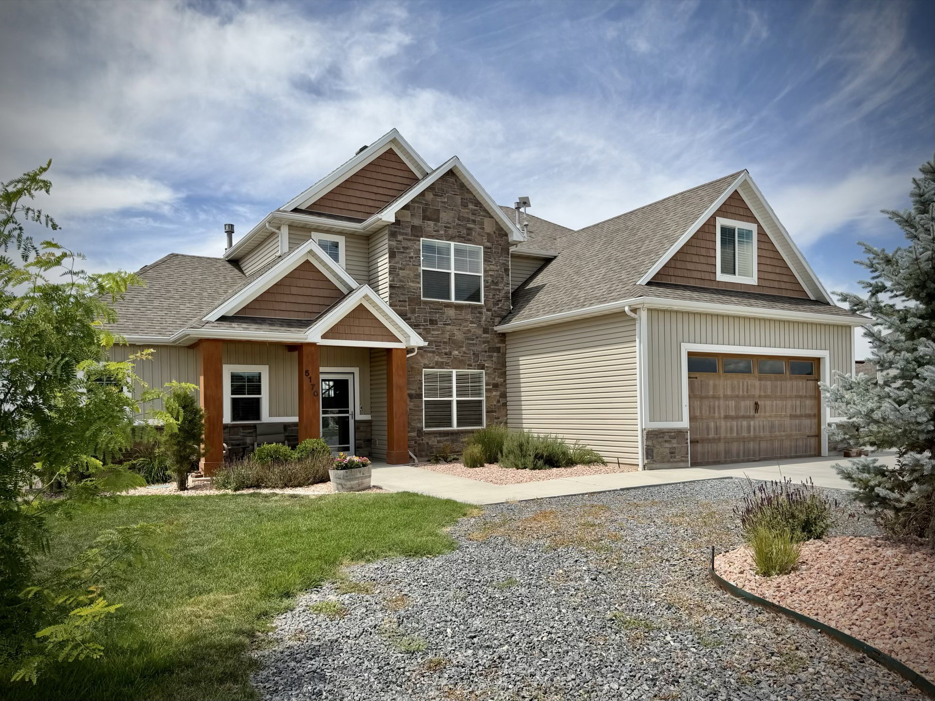 Multi-textured exterior featuring stone accents, horizontal siding, and vertical board-and-batten siding