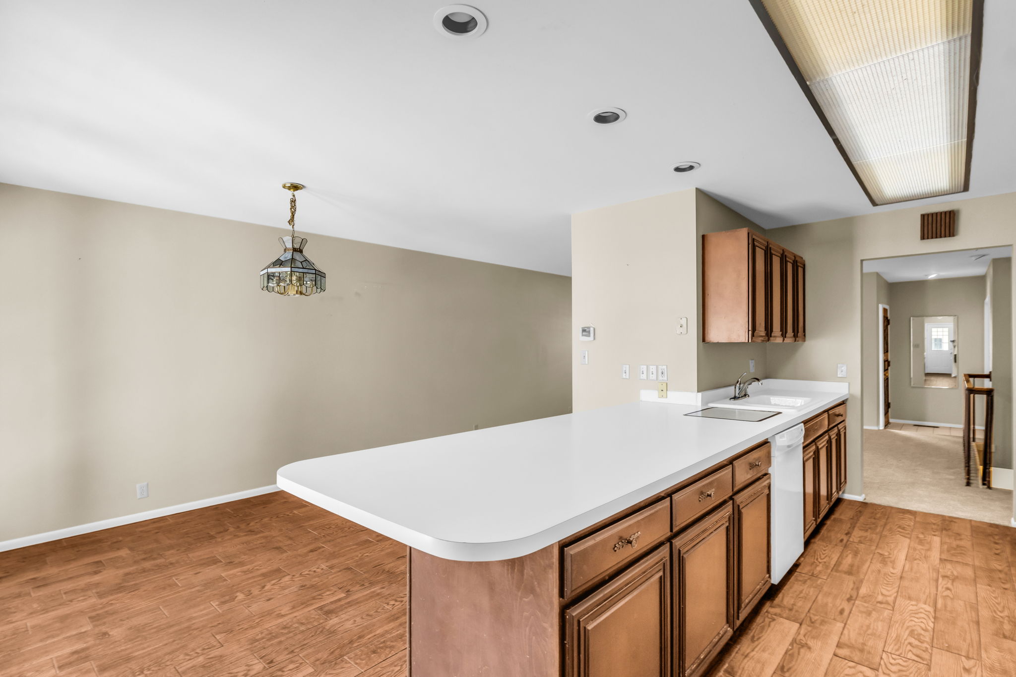 Kitchen island featuring a white countertop and wood cabinetry