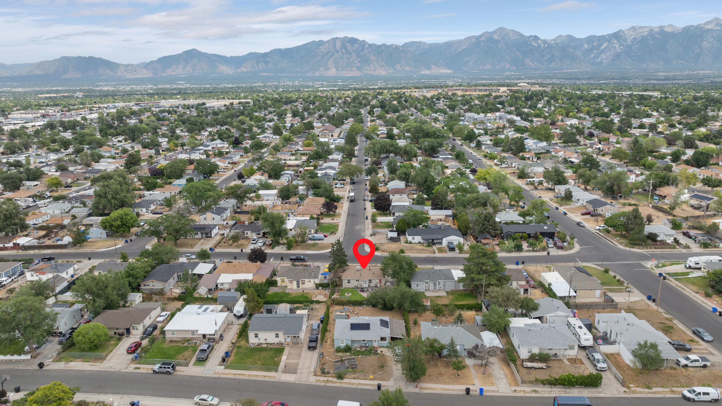 Aerial perspective showcasing a residential neighborhood with mountain backdrop