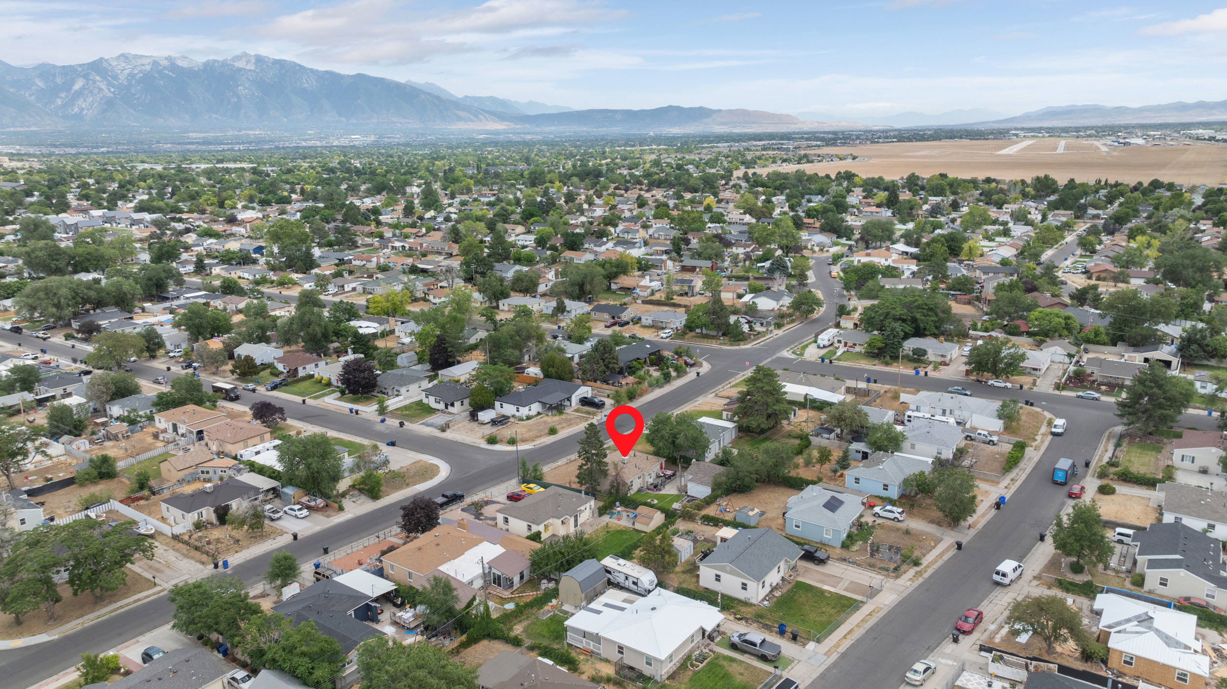 Aerial perspective showcasing a residential neighborhood with mountain backdrop