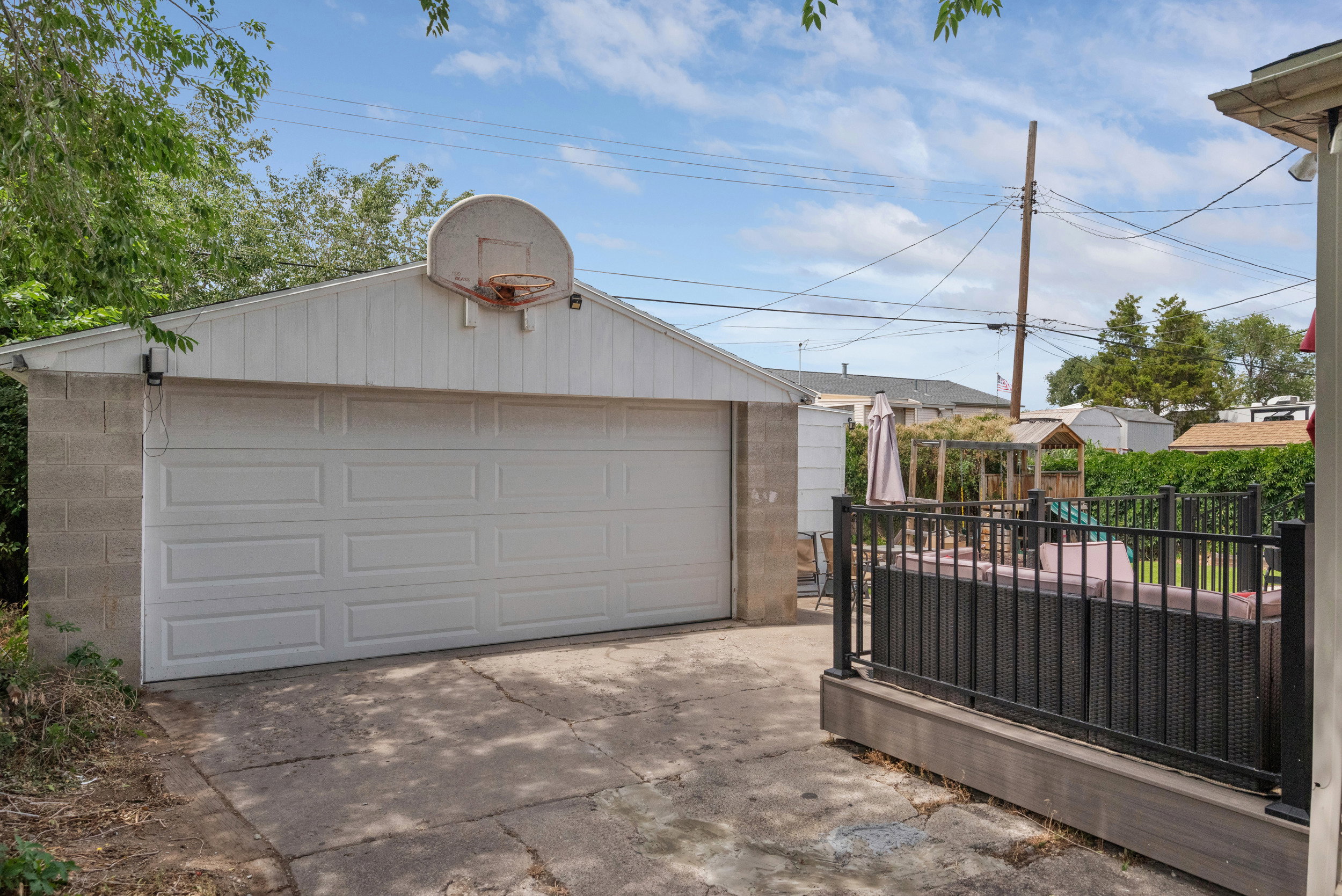 Detached two-car garage with a panel-style door and a basketball hoop