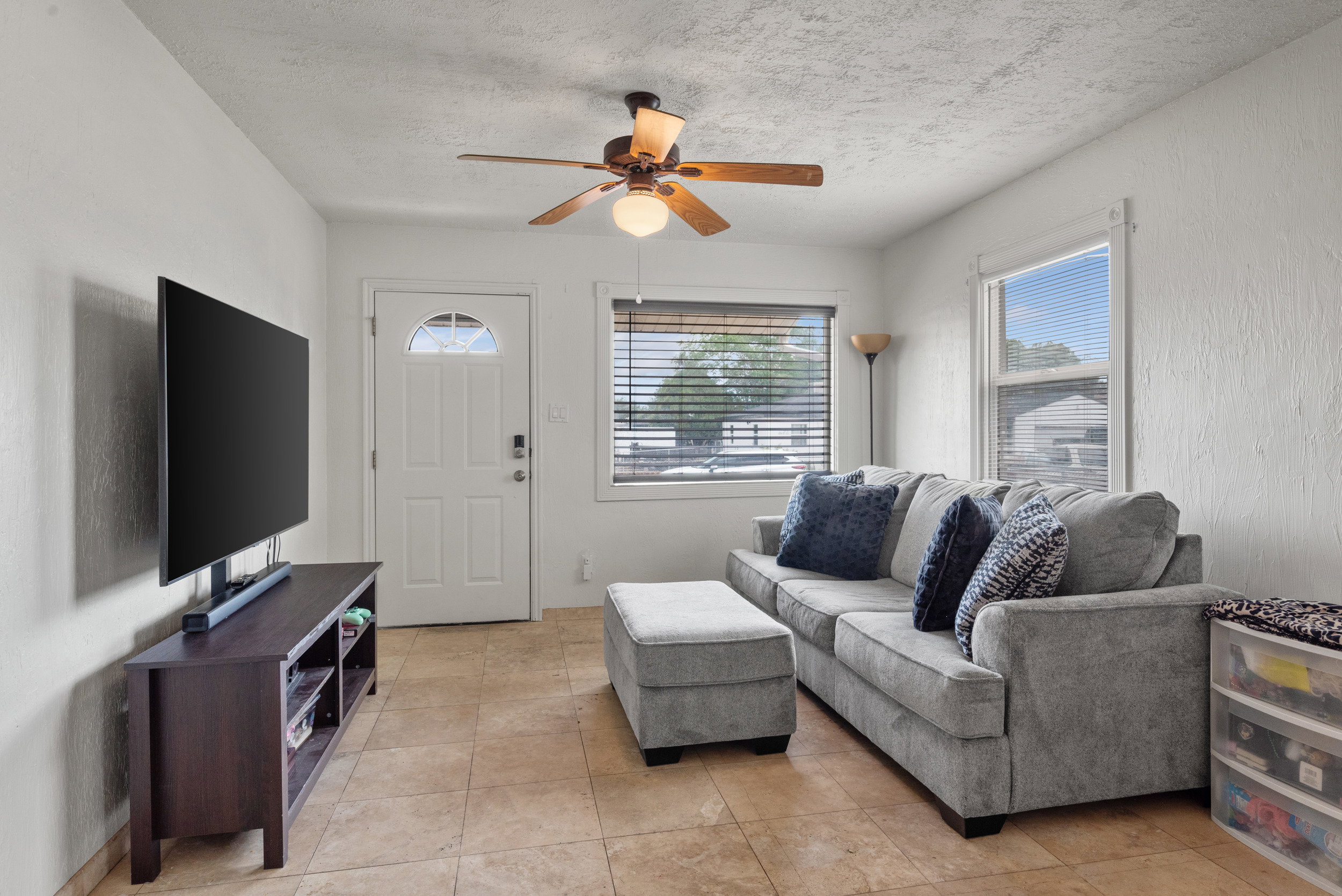 Living area featuring tiled flooring and neutral-toned walls