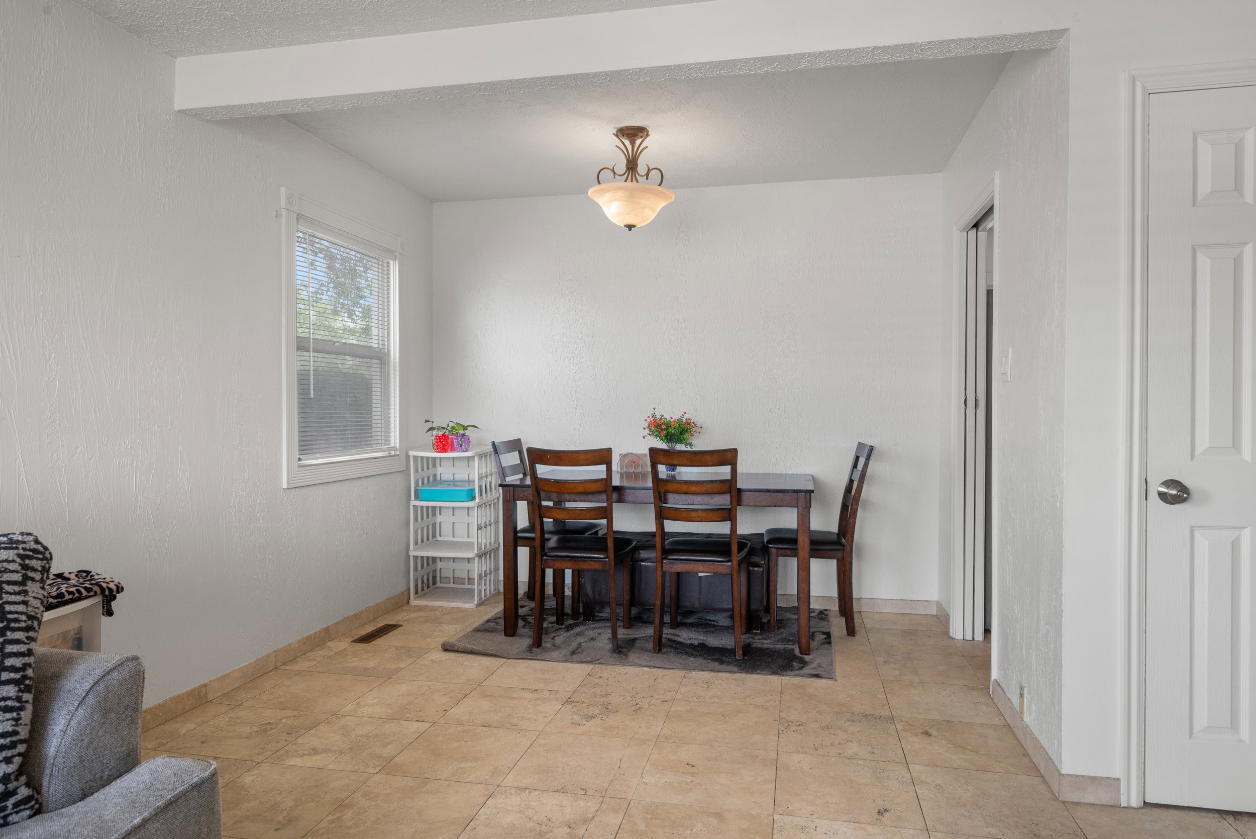 Dining area with tile flooring and a ceiling-mounted light fixture