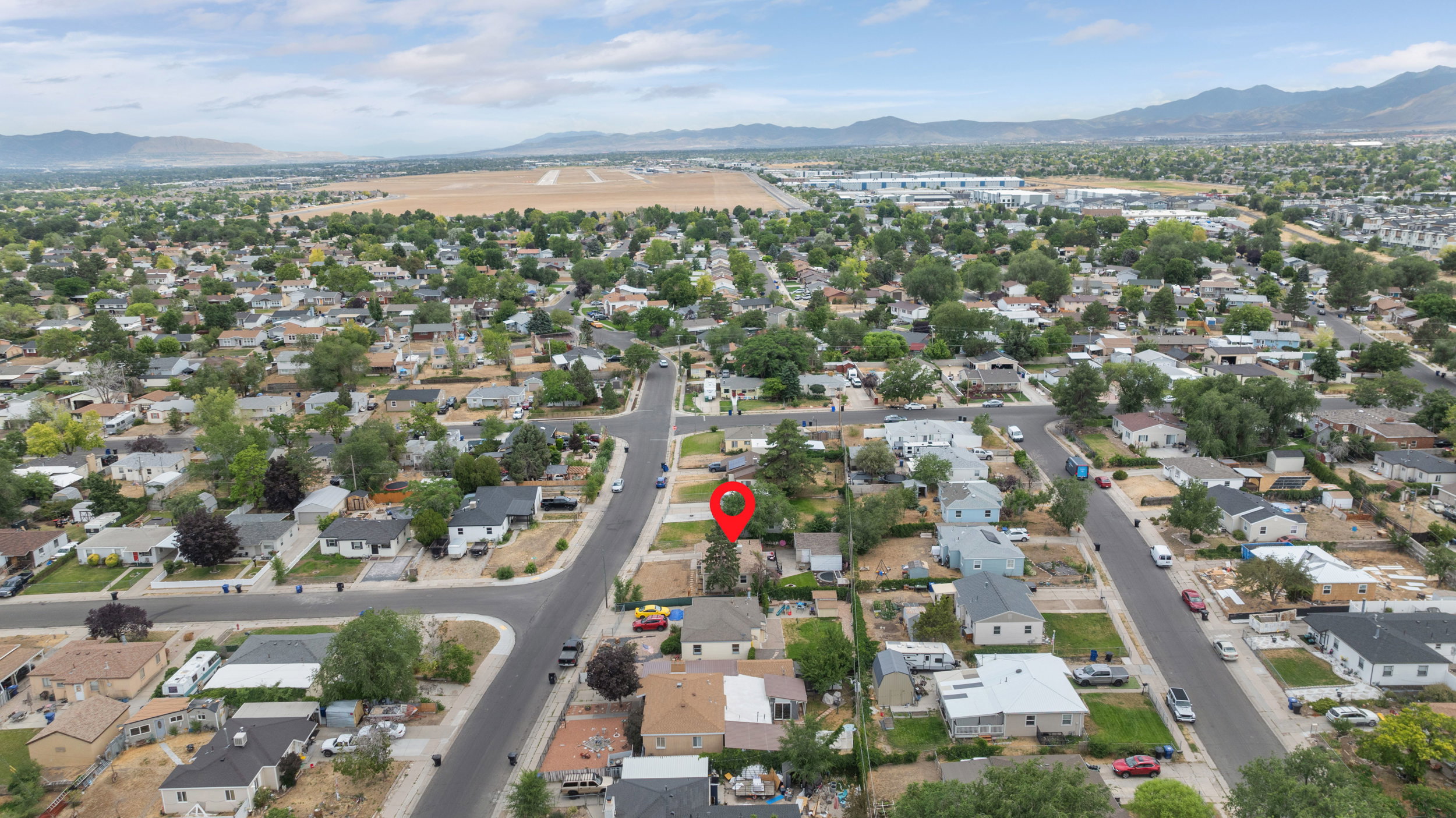 Aerial perspective showcasing a residential neighborhood with established homes and mature trees