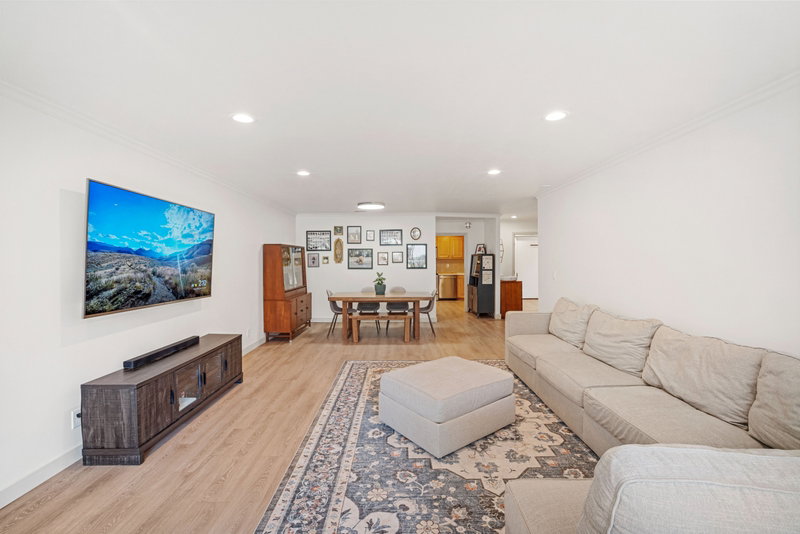 Open-concept living space featuring recessed lighting and wood-finish flooring