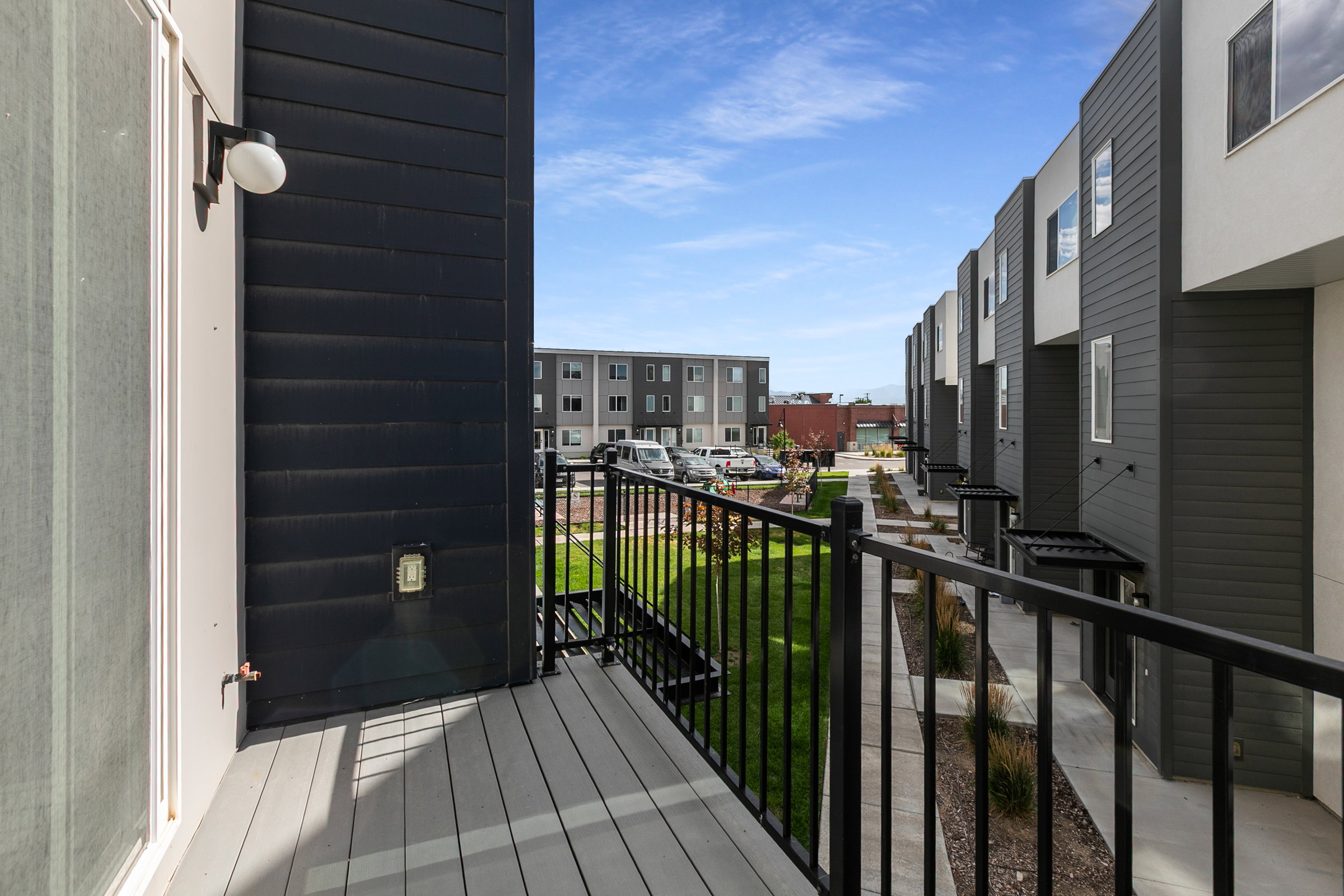 Private balcony with composite decking and black metal railing