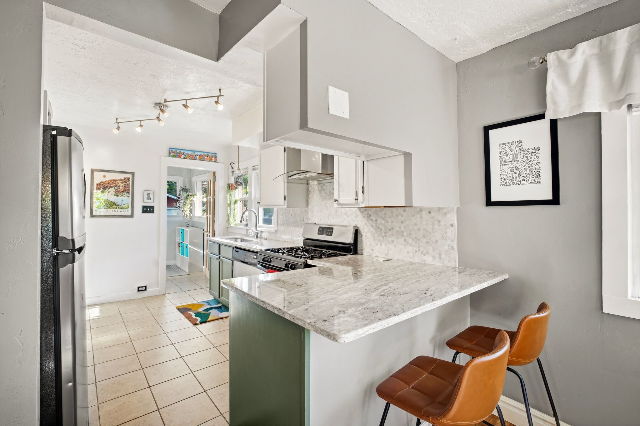 Kitchen featuring a breakfast bar with granite countertops and a tiled backsplash