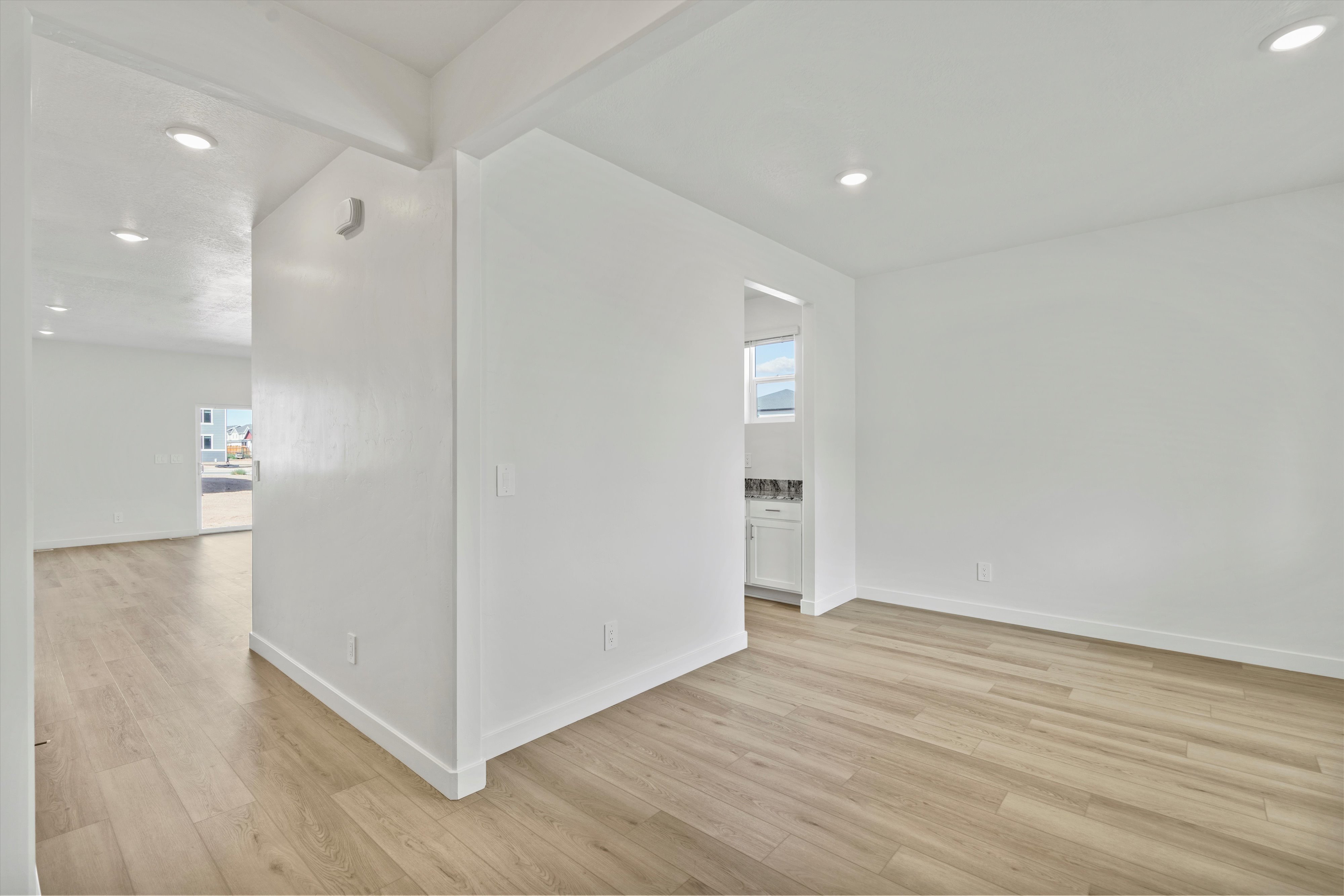 Interior space featuring light wood-finish flooring, recessed lighting, white walls, and white baseboards