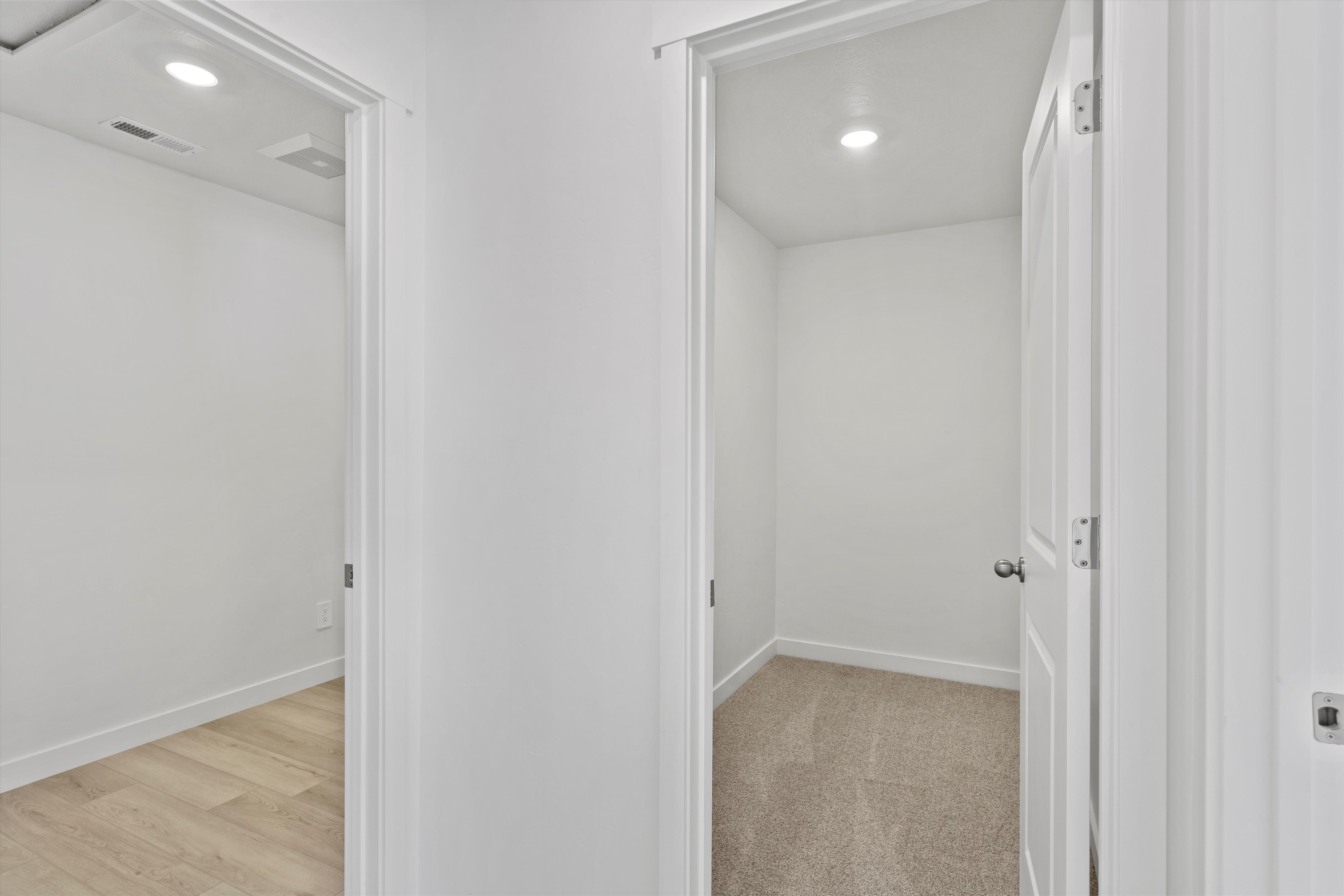 Corridor featuring two distinct doorways, each opening into a separate interior space