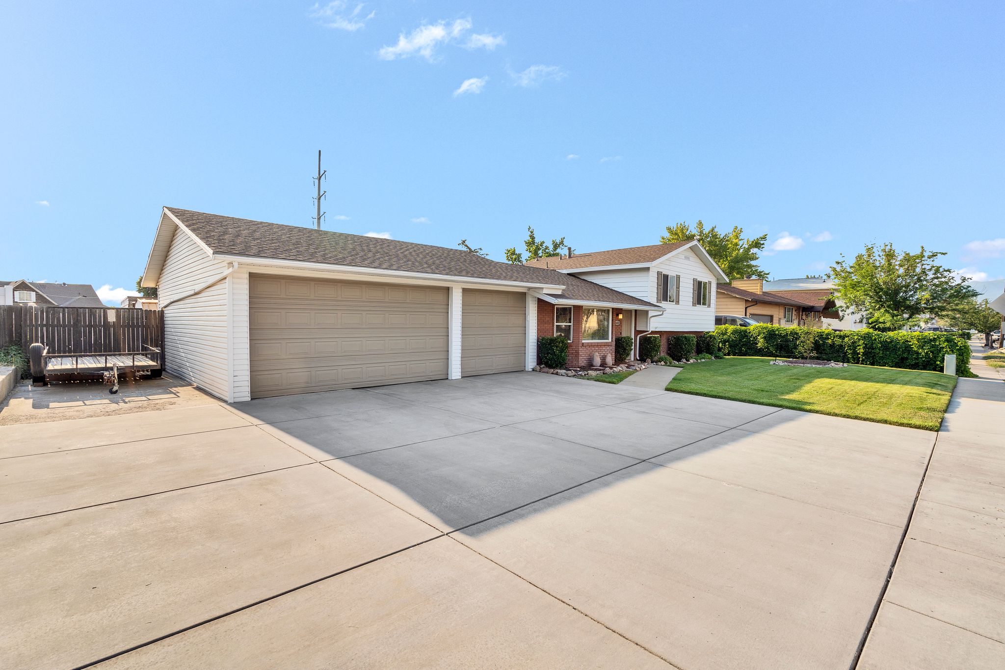 Two-car attached garage with concrete driveway