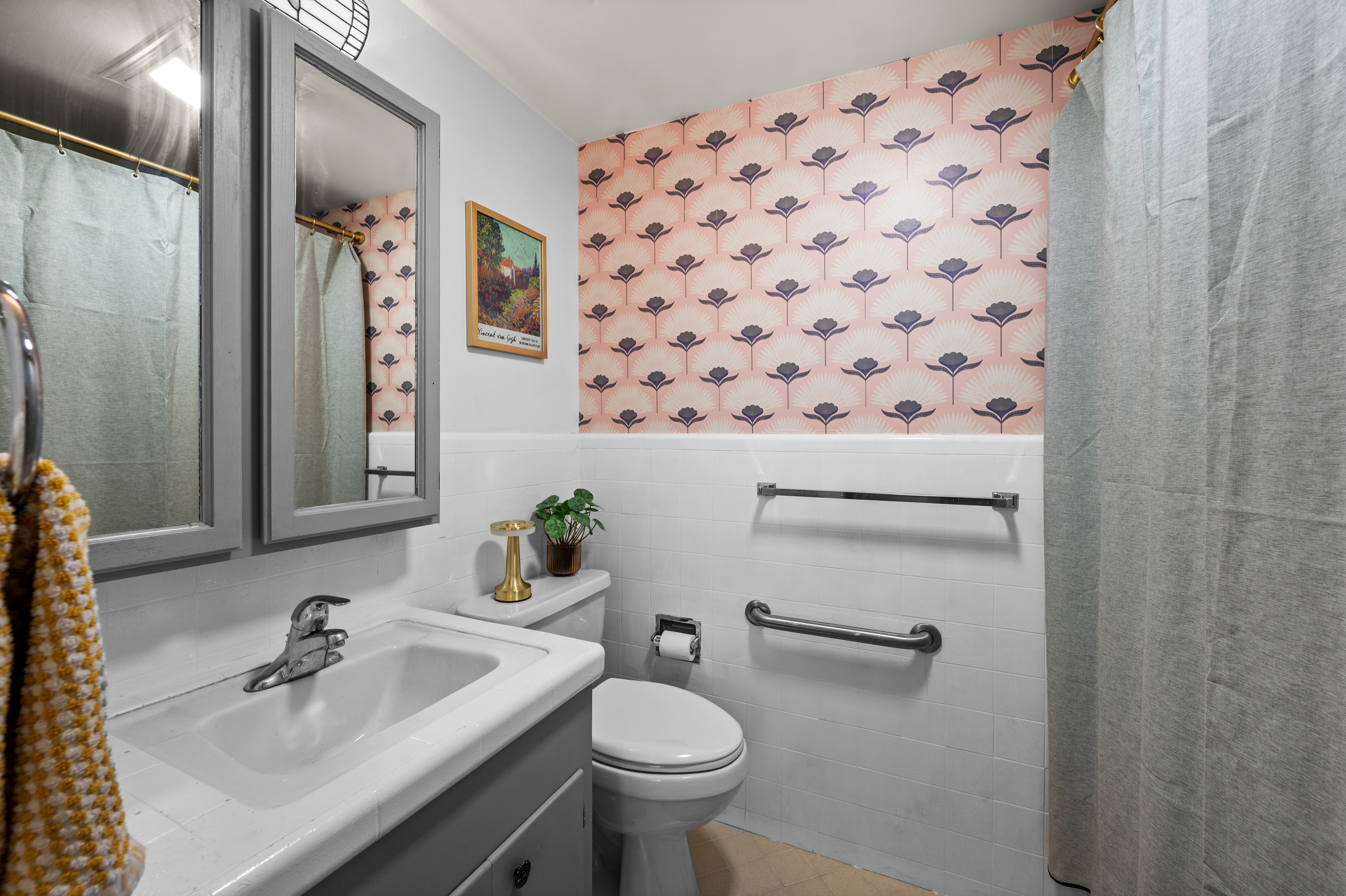 Bathroom featuring a single-basin sink with chrome fixtures, a two-door medicine cabinet with integrated mirrors, and a toilet