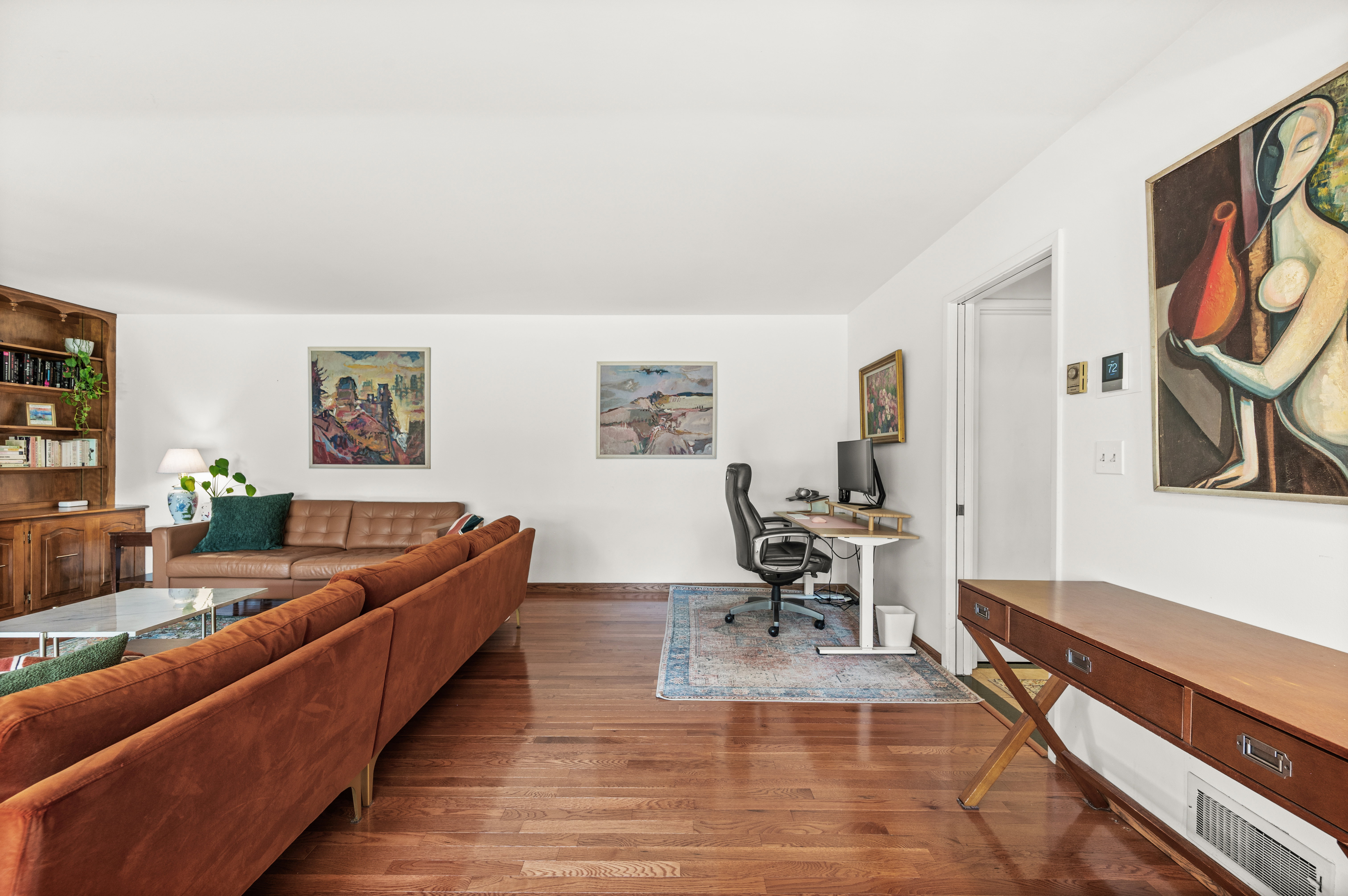 Open-concept living area featuring wood-finish flooring throughout