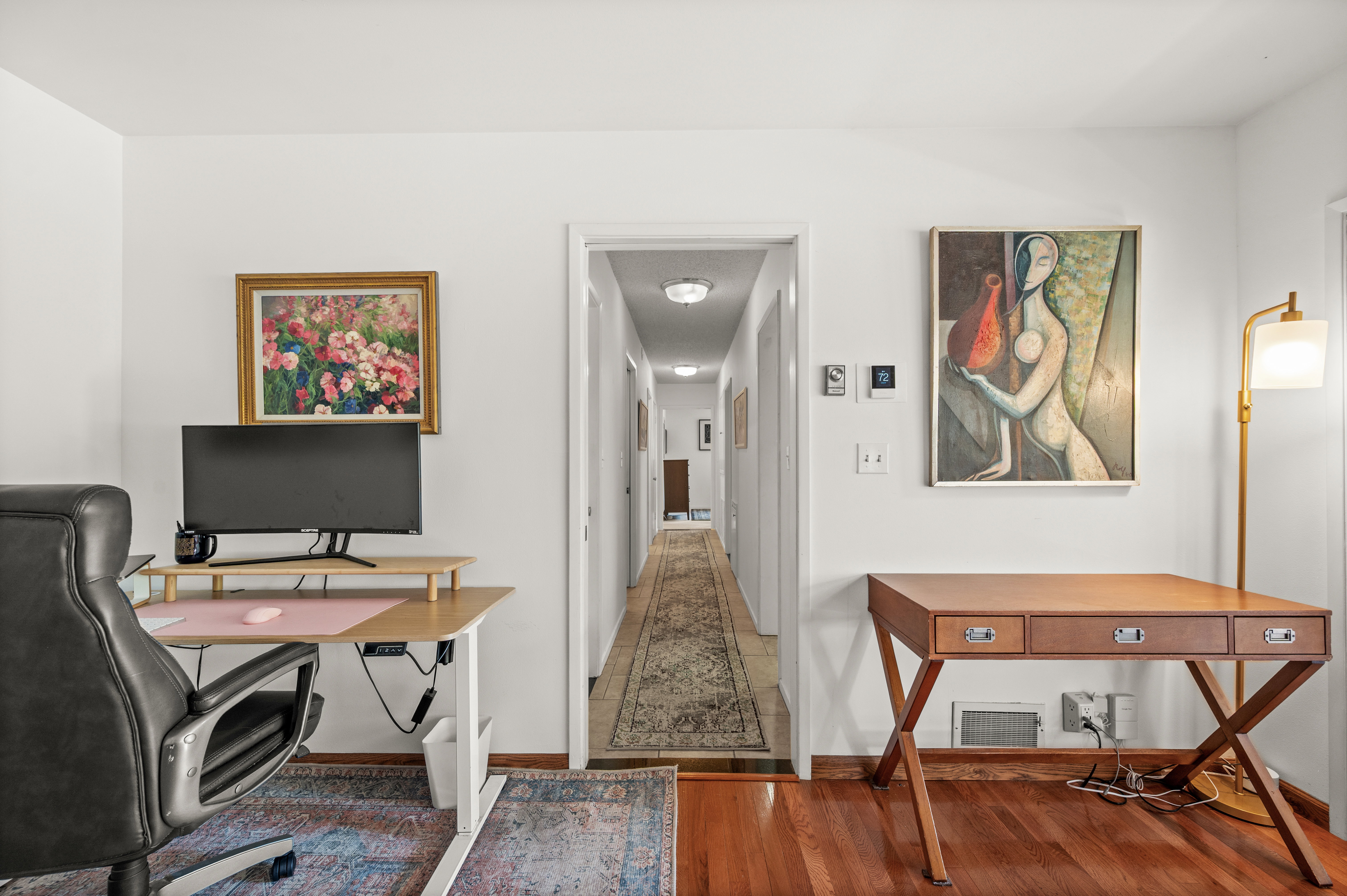Interior space with hardwood flooring and white walls