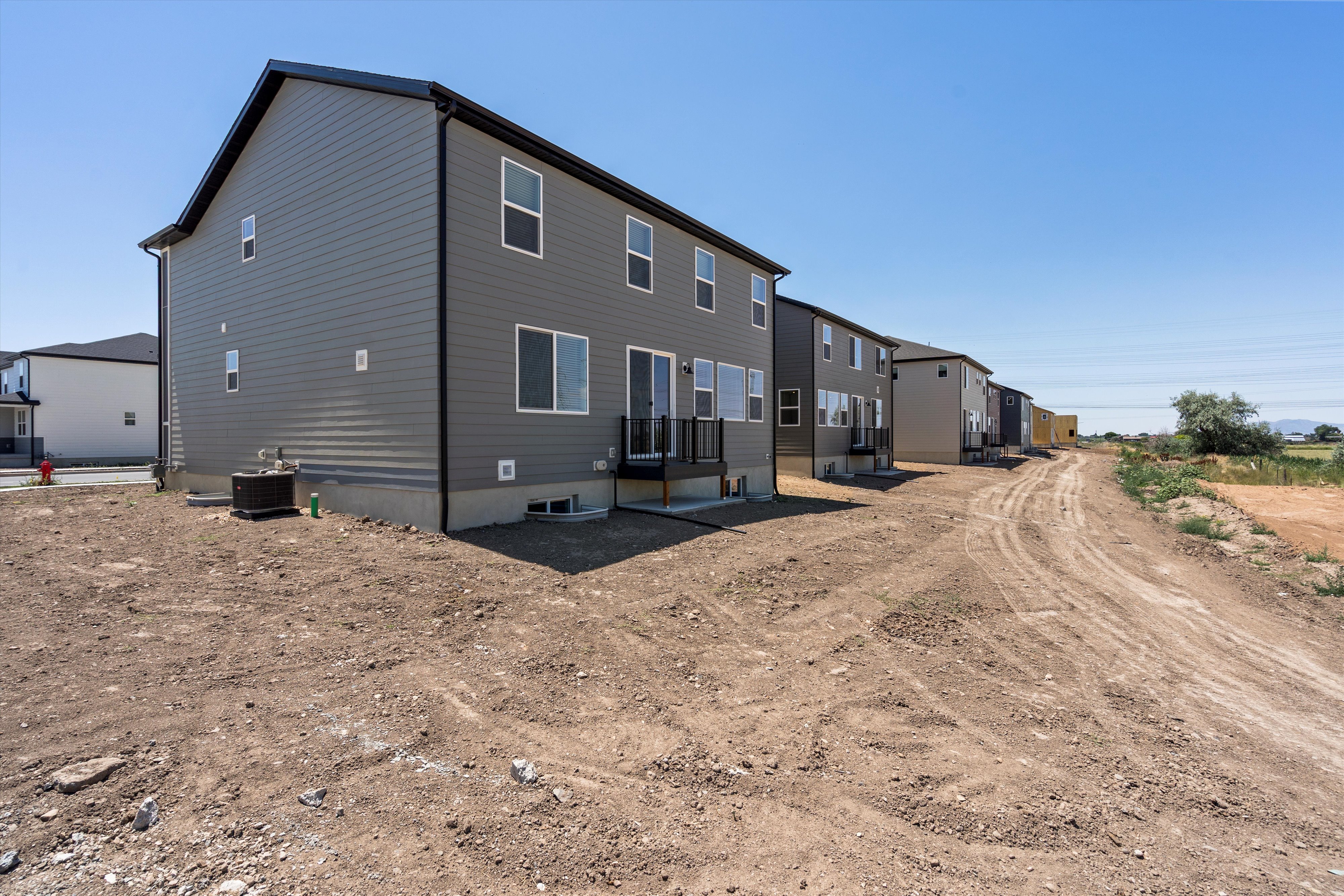 Newly constructed residential property featuring dark gray horizontal siding and black trim
