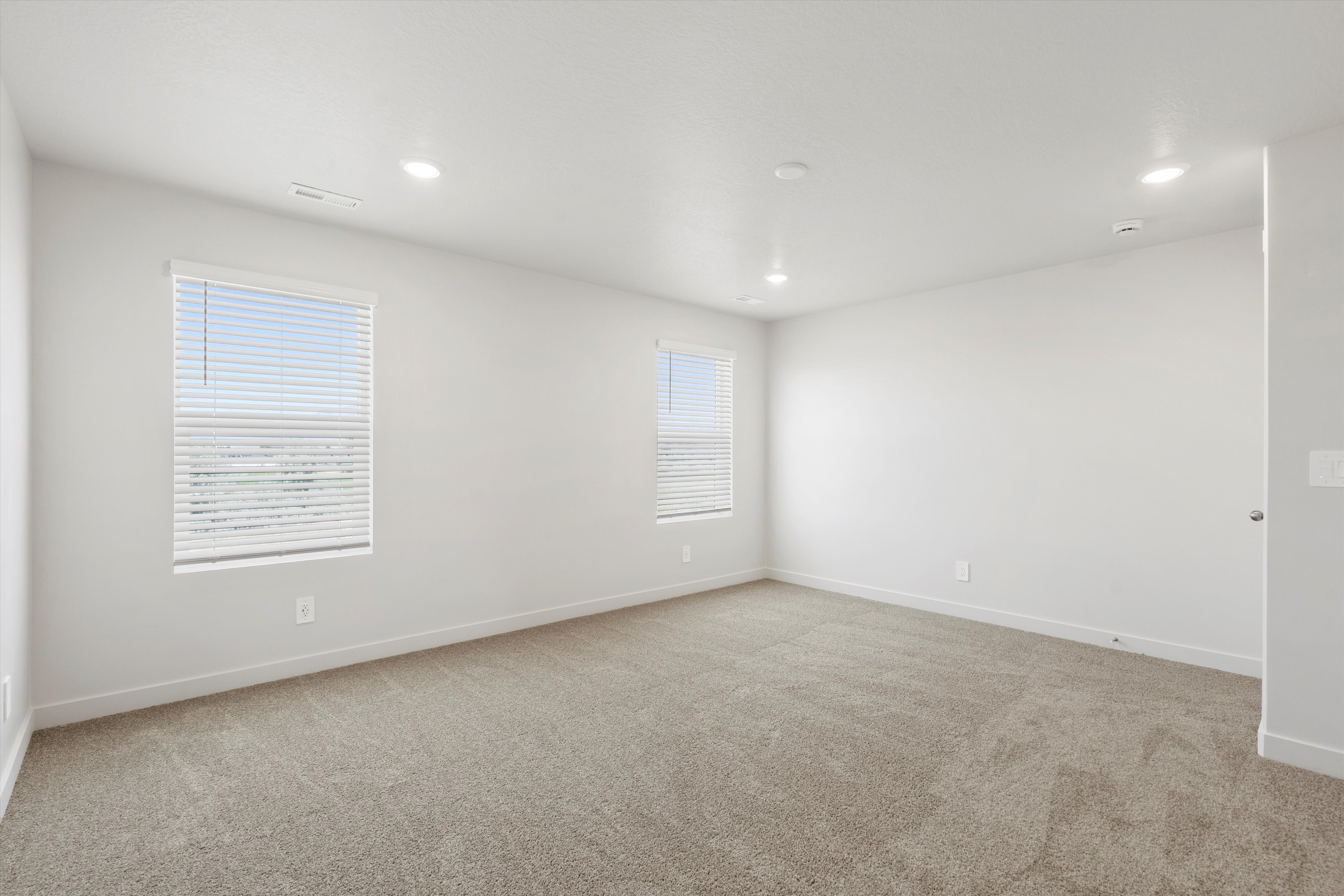**DISCLAIMER** Interior package may vary. Spacious room featuring neutral carpeting and white walls