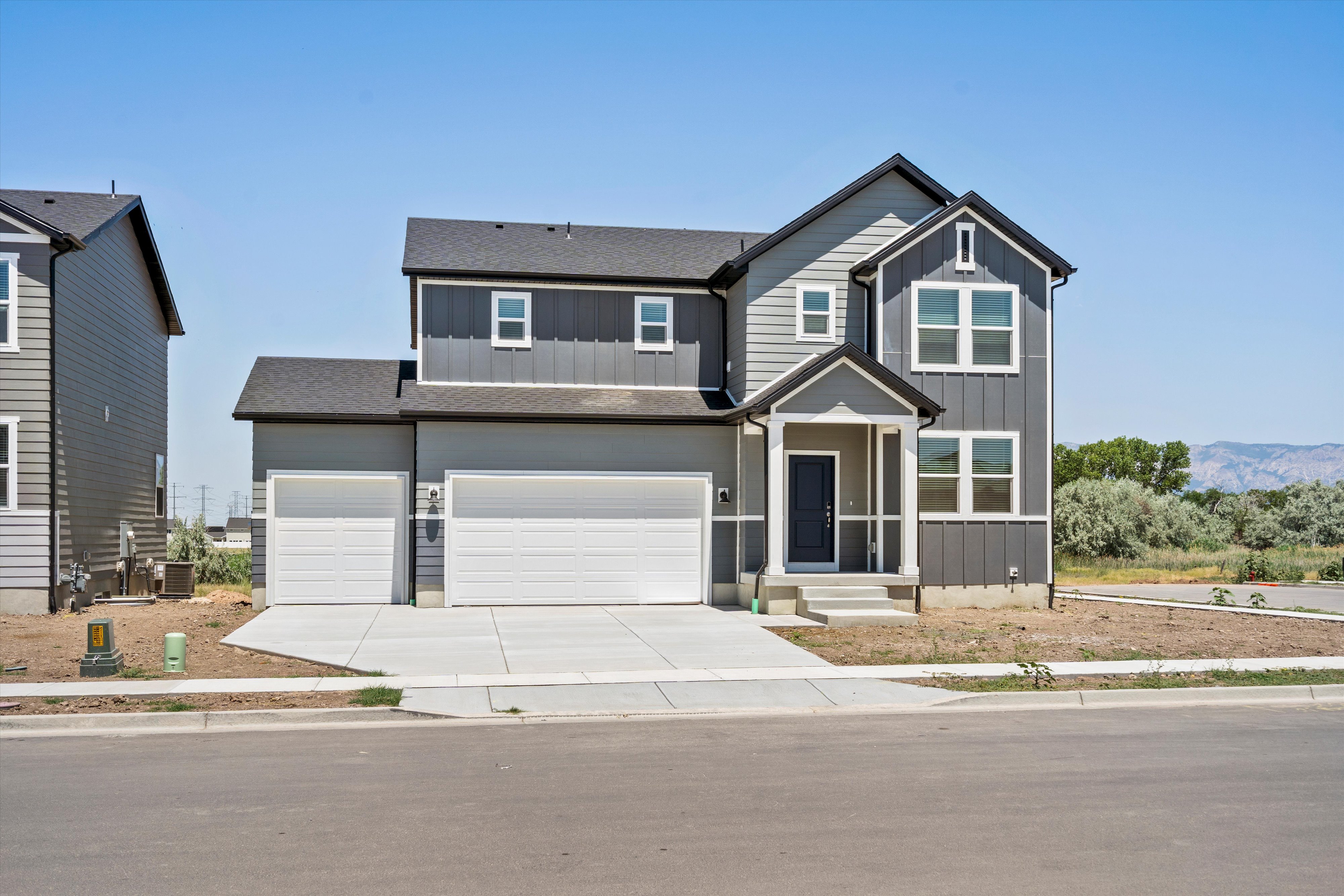 Contemporary two-story residence with a gray and dark gray siding facade