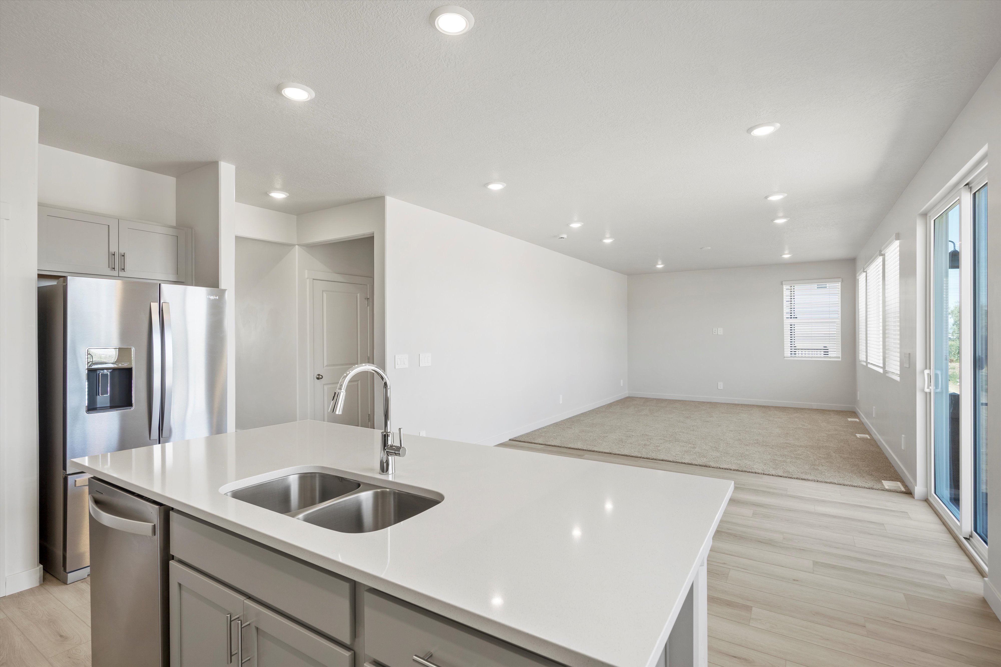 **DISCLAIMER** Interior package may vary. Modern kitchen island featuring a dual basin sink and polished chrome faucet