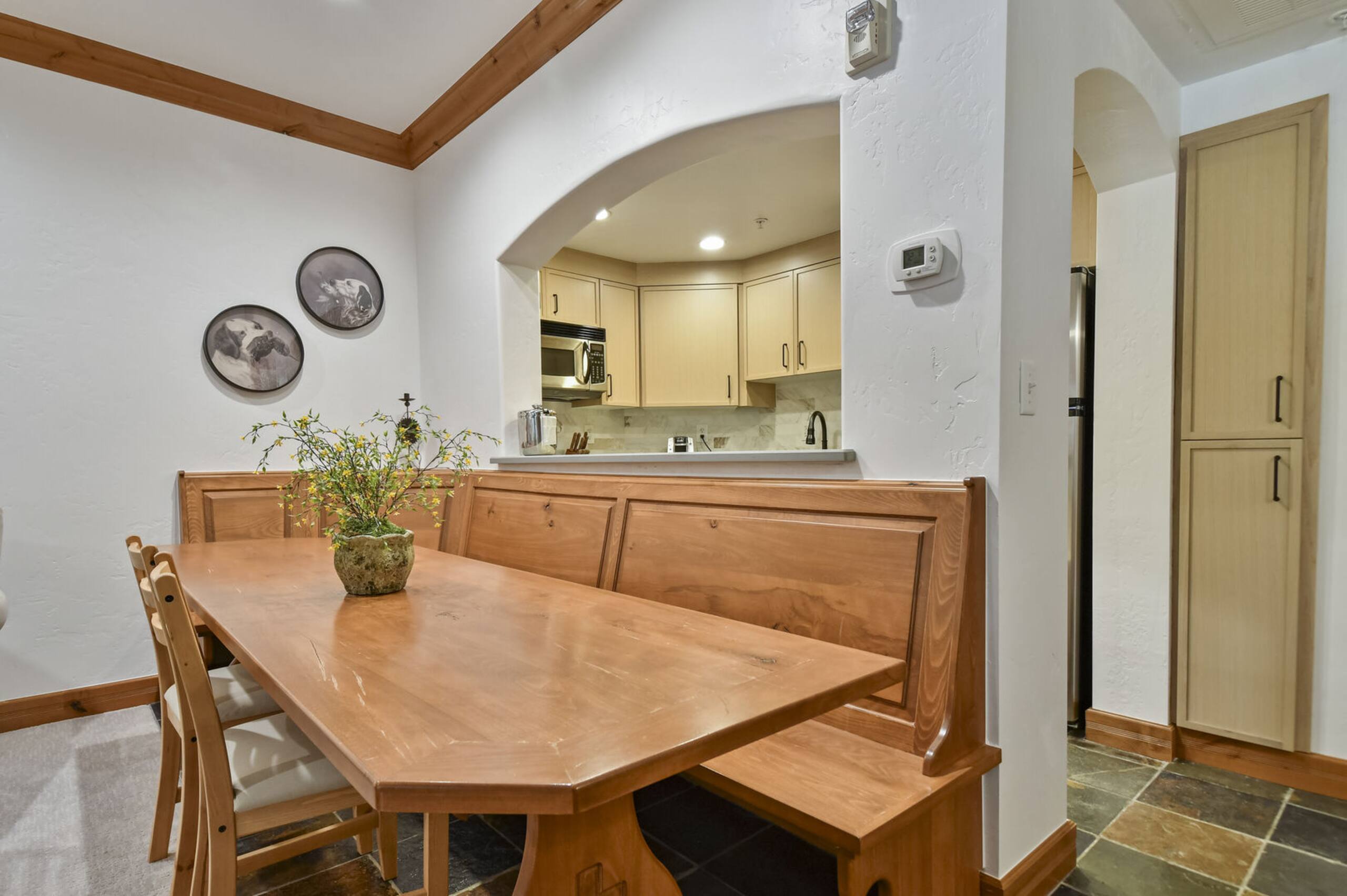 Built-in dining nook with wood-finish seating and table