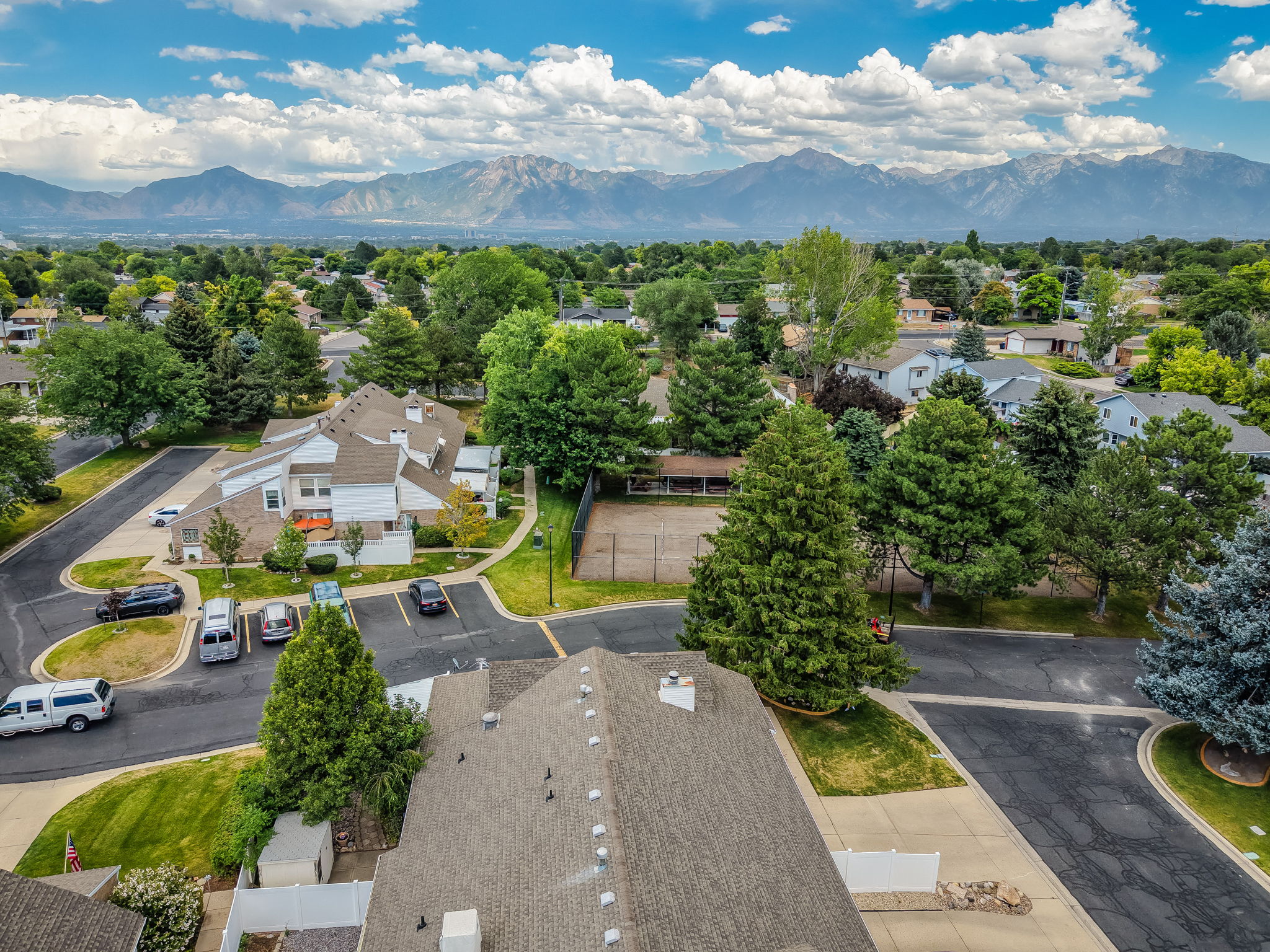 Townhome community featuring multi-level units with exterior balconies and dedicated parking areas