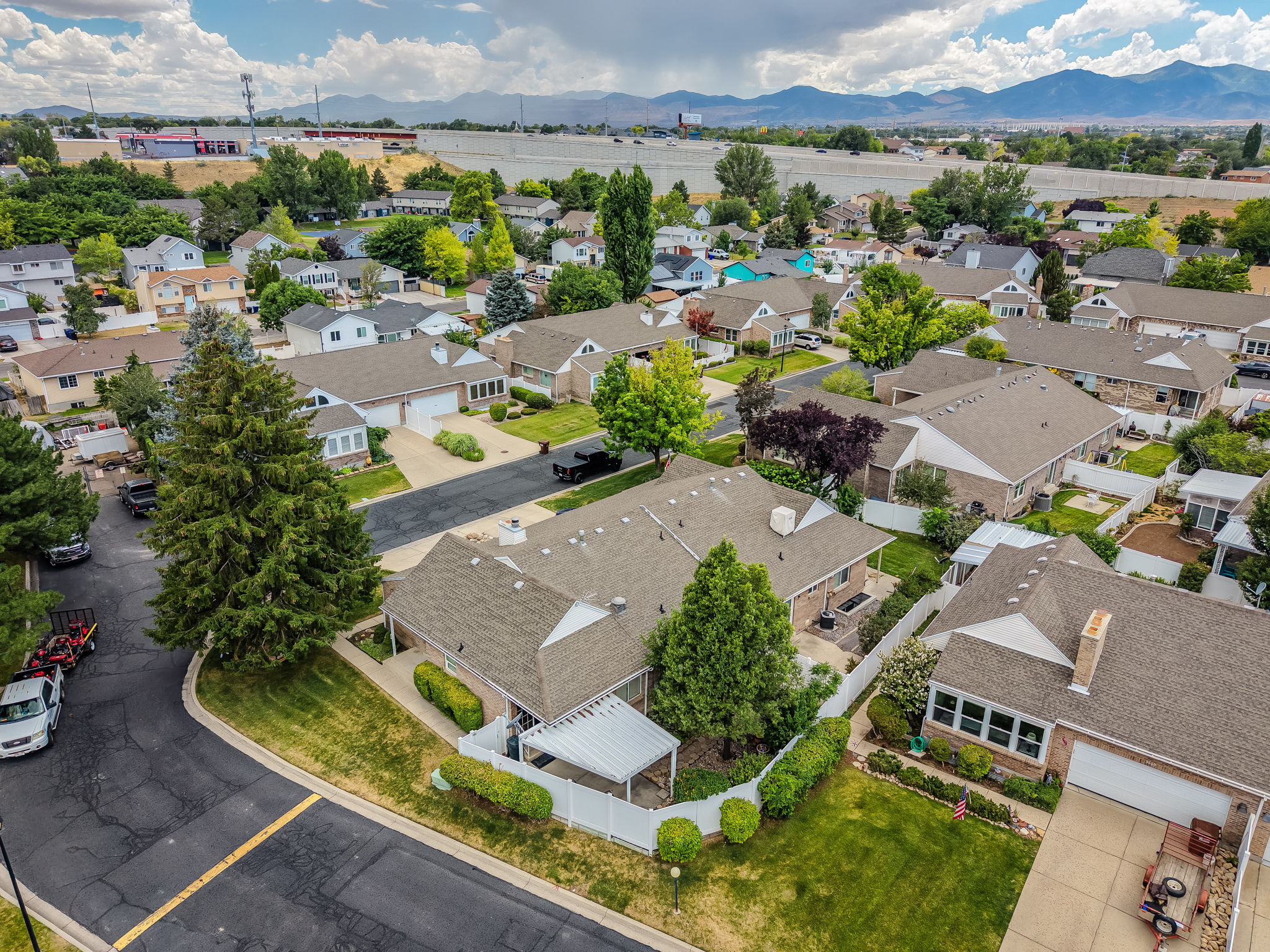 Aerial perspective showcasing a residential community with varied rooflines and mature trees