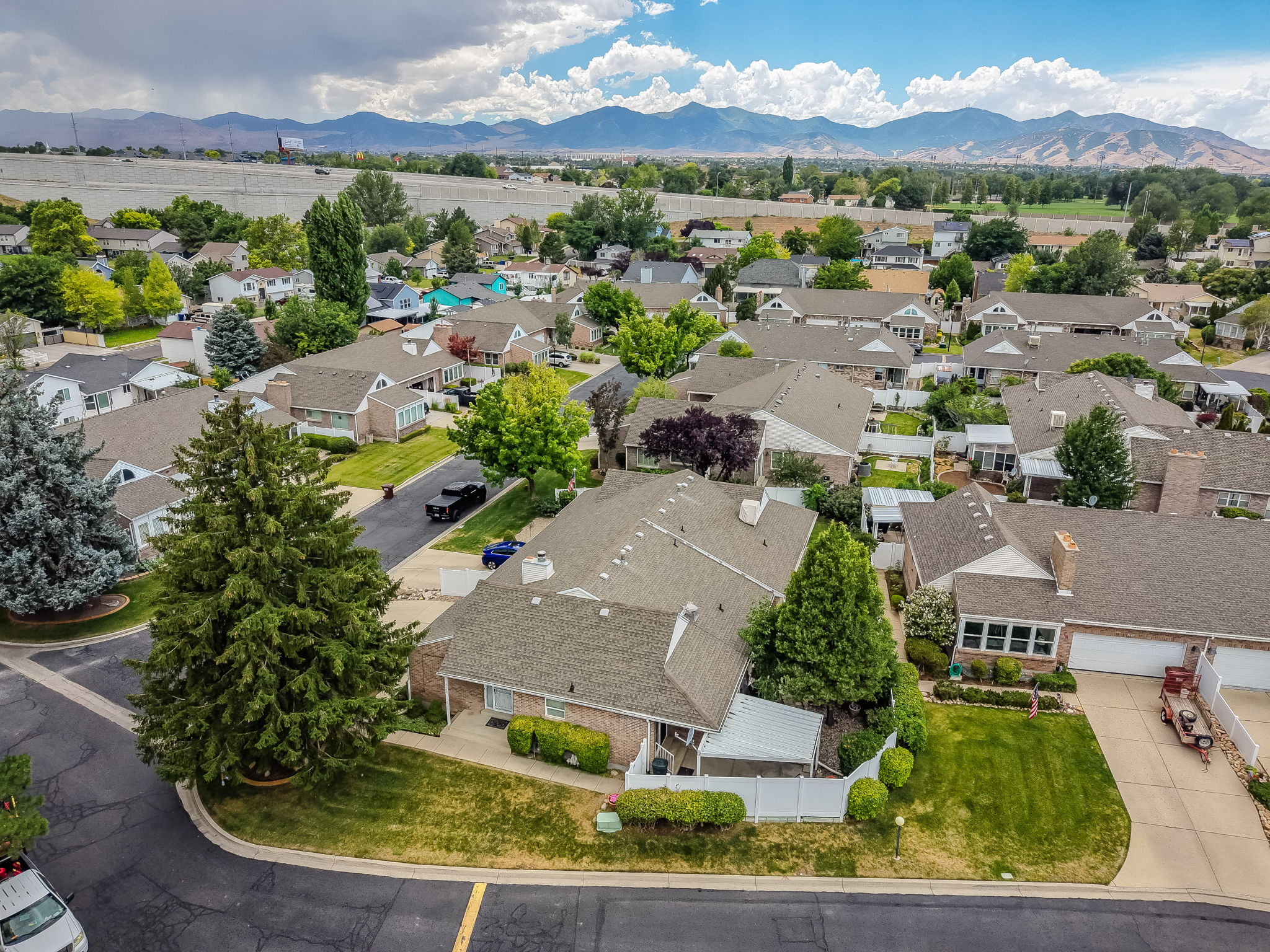 Aerial perspective showcasing a residential neighborhood with distant mountain ranges