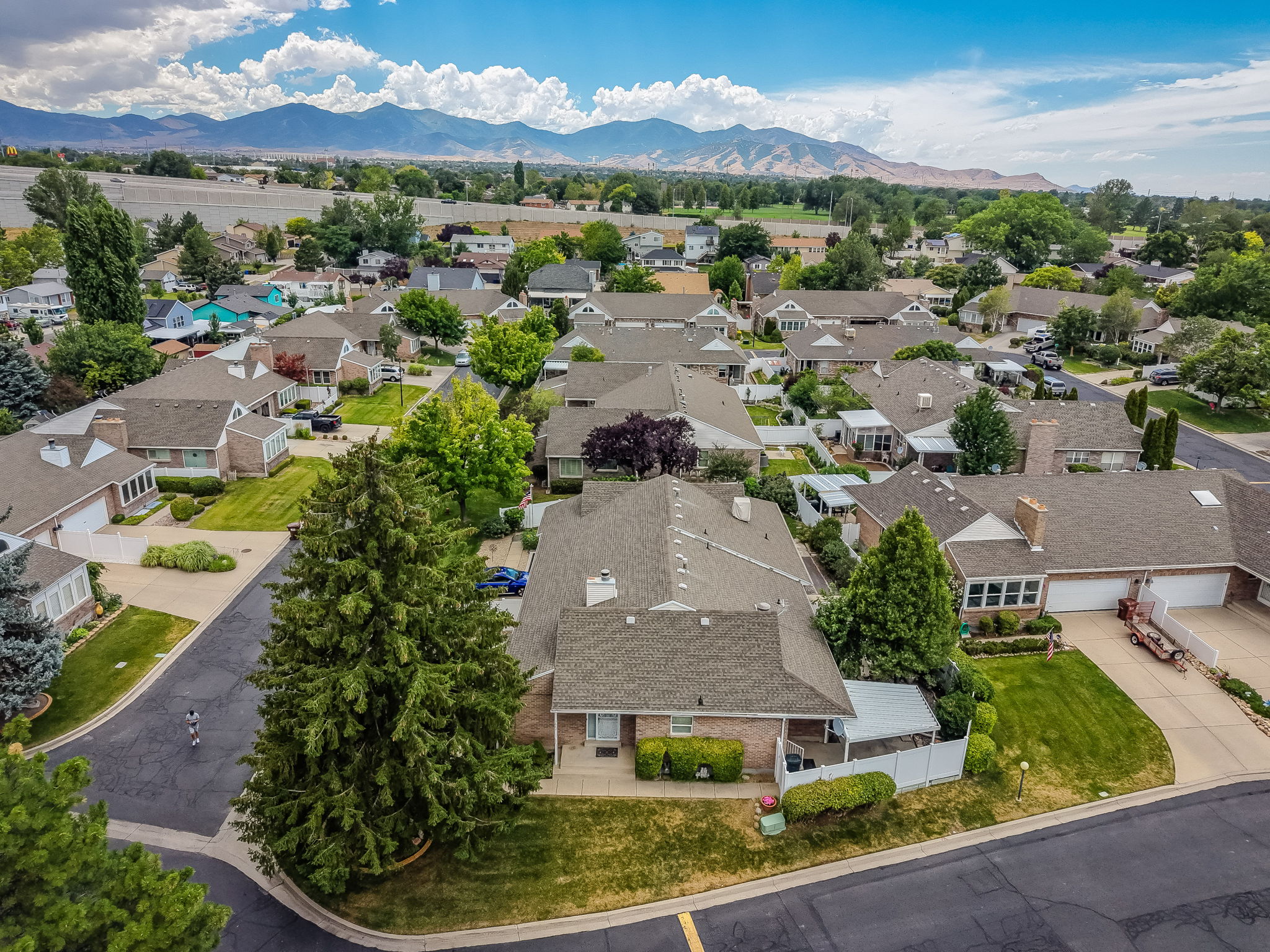 Residential neighborhood featuring a variety of single-story homes with shingle roofs and brick exteriors