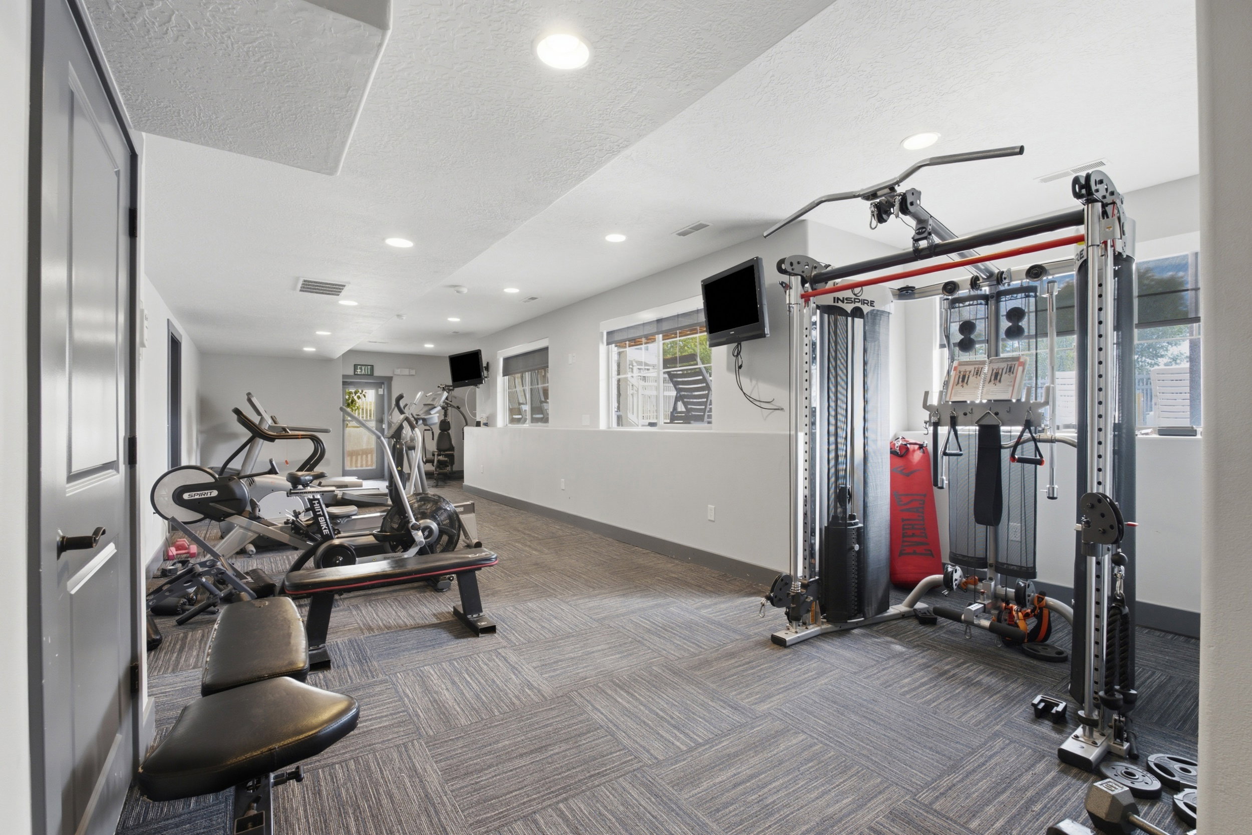 Dedicated fitness room featuring recessed lighting and patterned carpet flooring