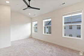 Carpeted room featuring a vaulted ceiling with recessed lighting and a contemporary ceiling fan