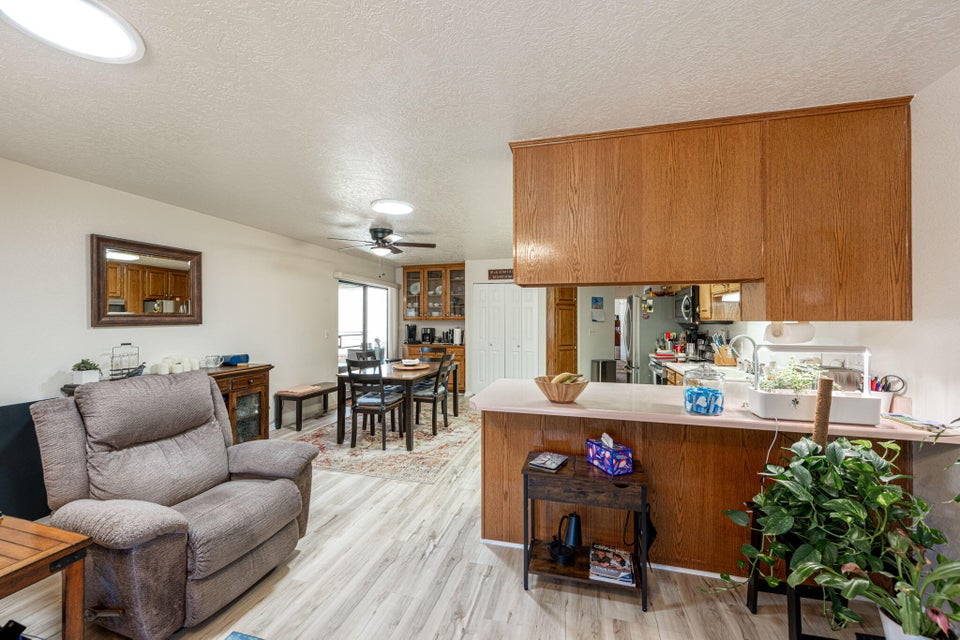 Open-concept living space featuring wood-finish flooring, recessed lighting, and a neutral color palette